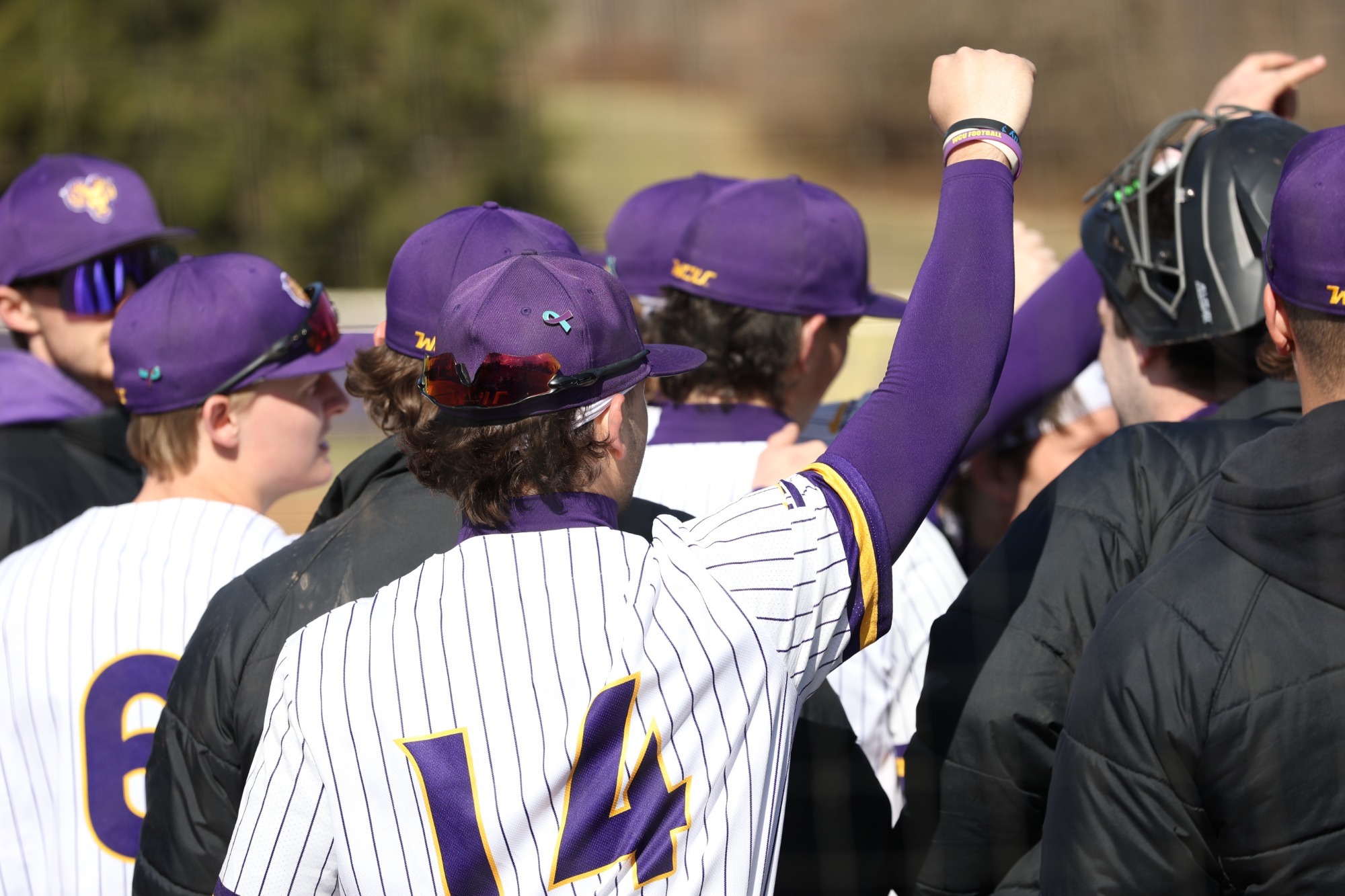 BASEBALL TEAM ACTION SHOT IN WHITE PINSTRIPE UNIFORMS