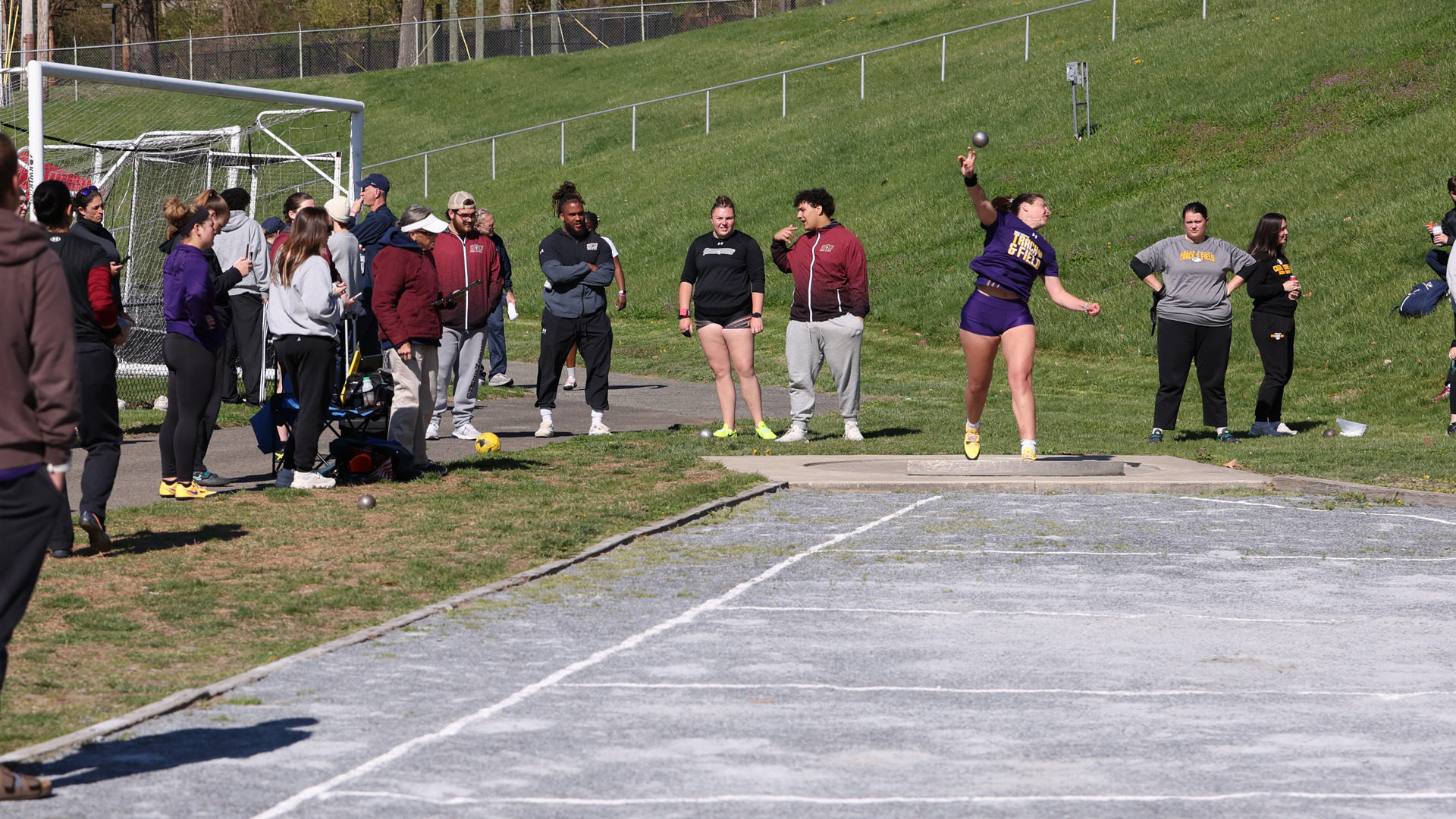 Emma Deyarmin puts the shot at a home meet