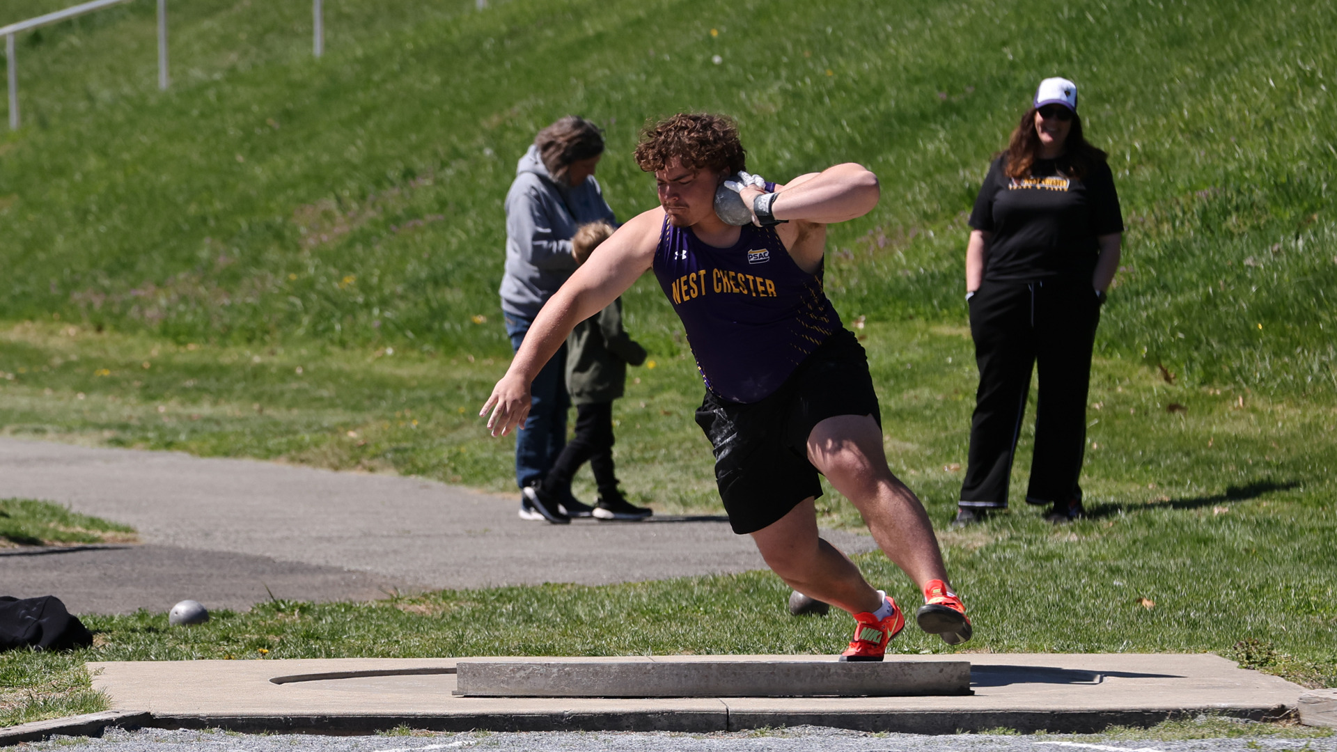 Jake Joslin spins in preparation of putting the shot at Farrell Stadium