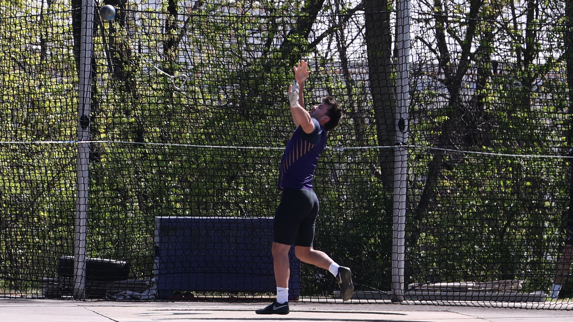 Collin Niedrowski throws the hammer in West Chester's throw cage