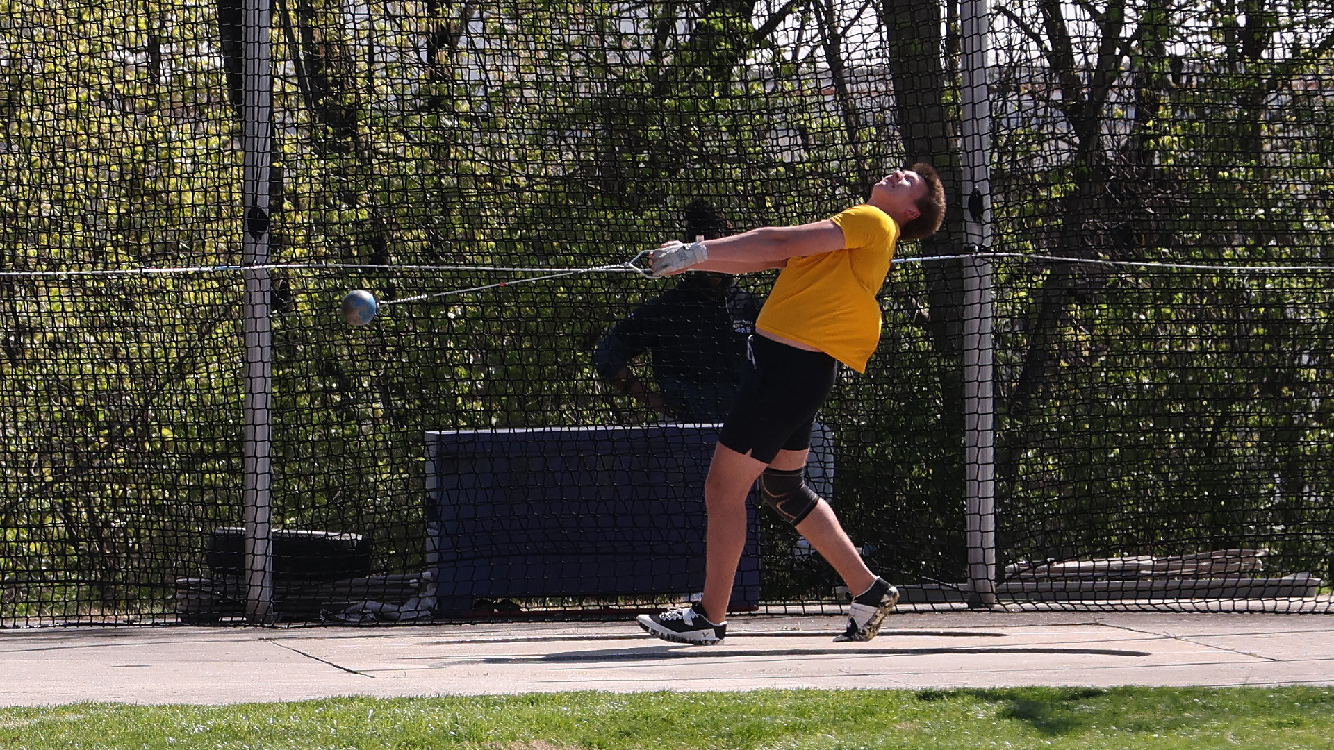 Brodyn Wolfert throws the hammer in West Chester's throw cage 