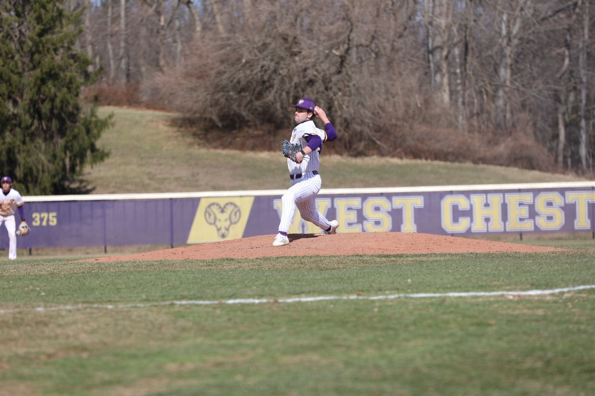 Nick Cugino wearing home white pinstripes pitching vs Gannon on 3-14-26