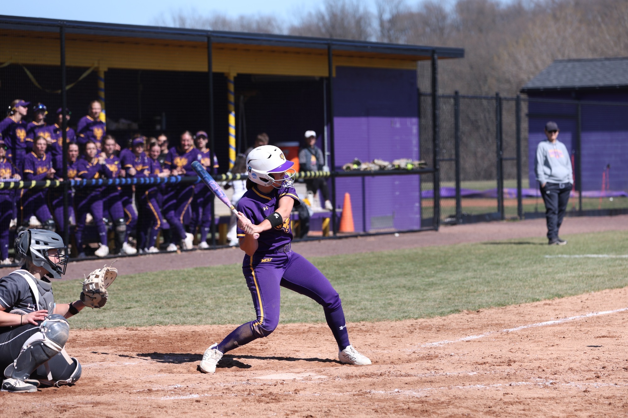 Emma Zoldi batting vs Lock Haven on 3-21-26 wearing new home all purple uniforms