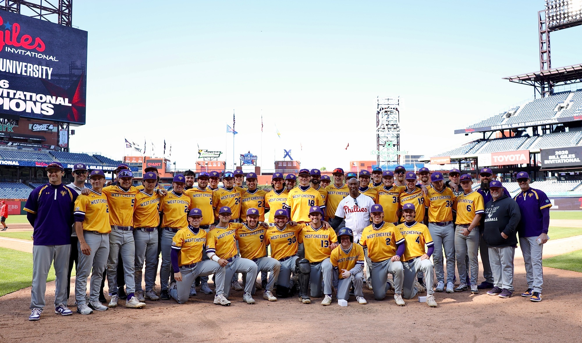 Baseball team behind home plate following bill giles invitational championship on Tuesday