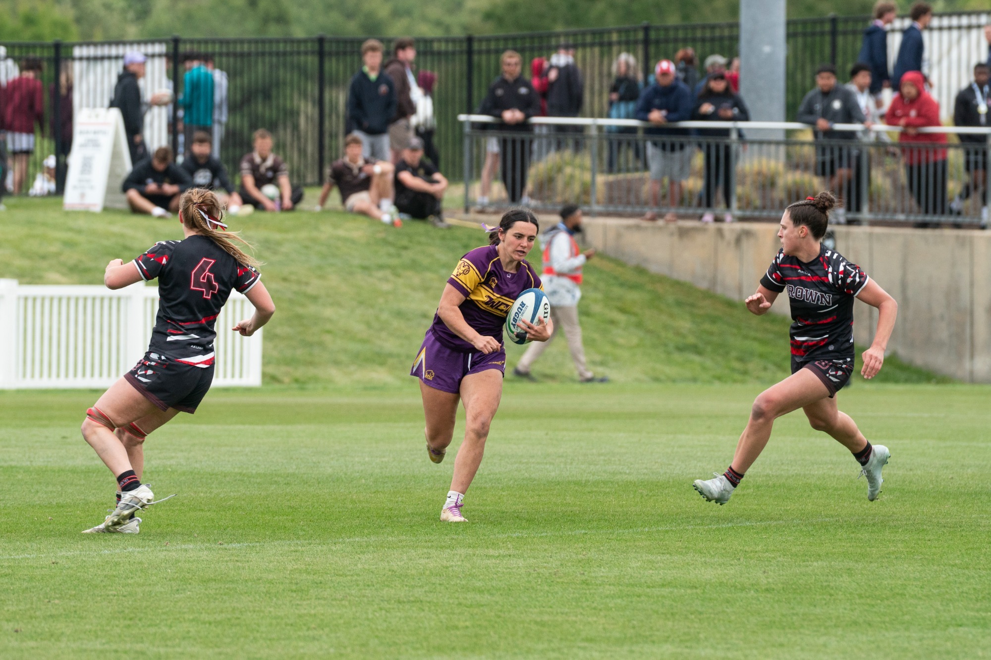 Women's Rugby player looking to split two defenders at CRC Championships at Maryland SoccerPlex