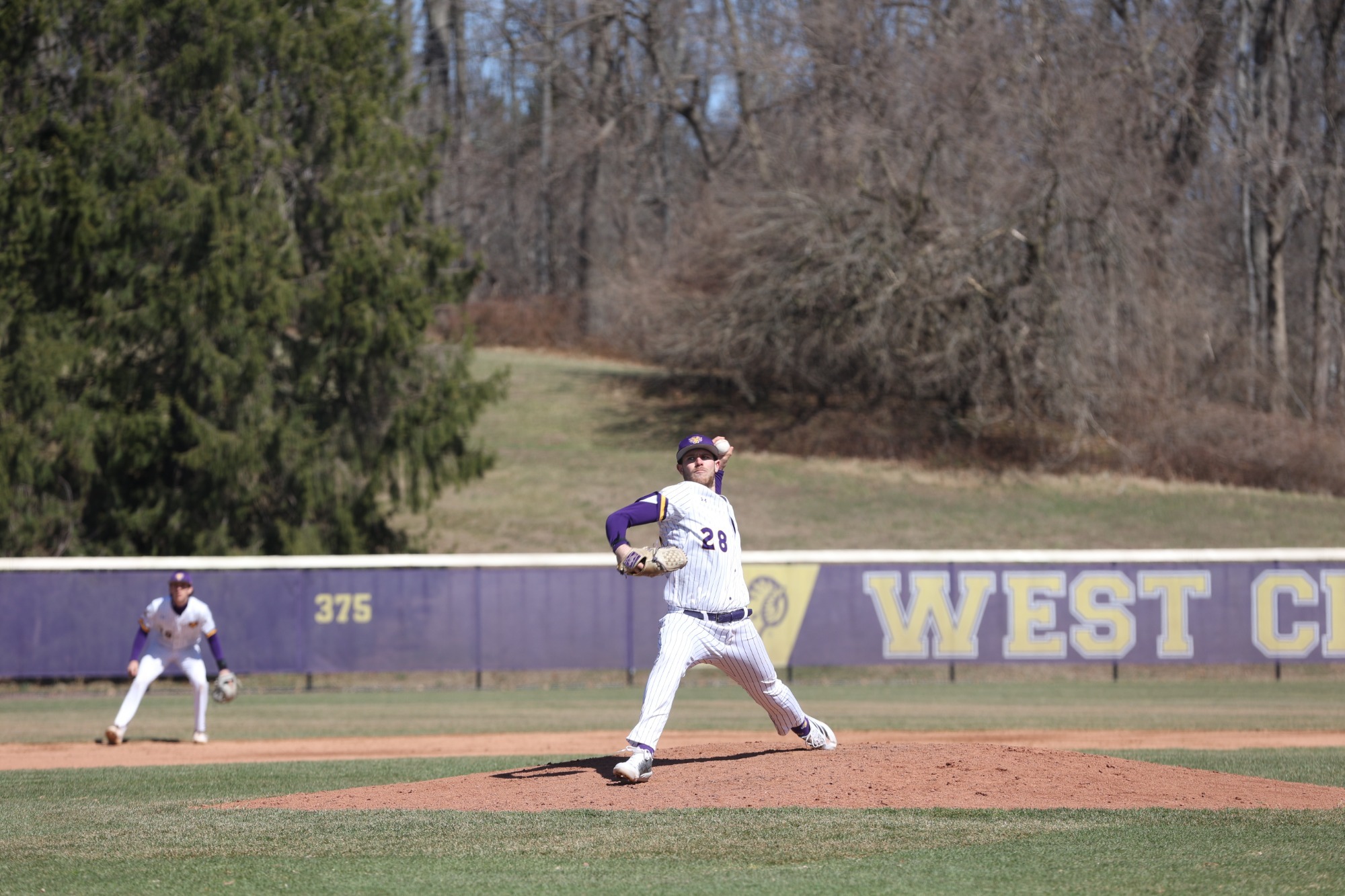 Julian Costa pitching at home in home white pinstripes vs Gannon on 3-14-26
