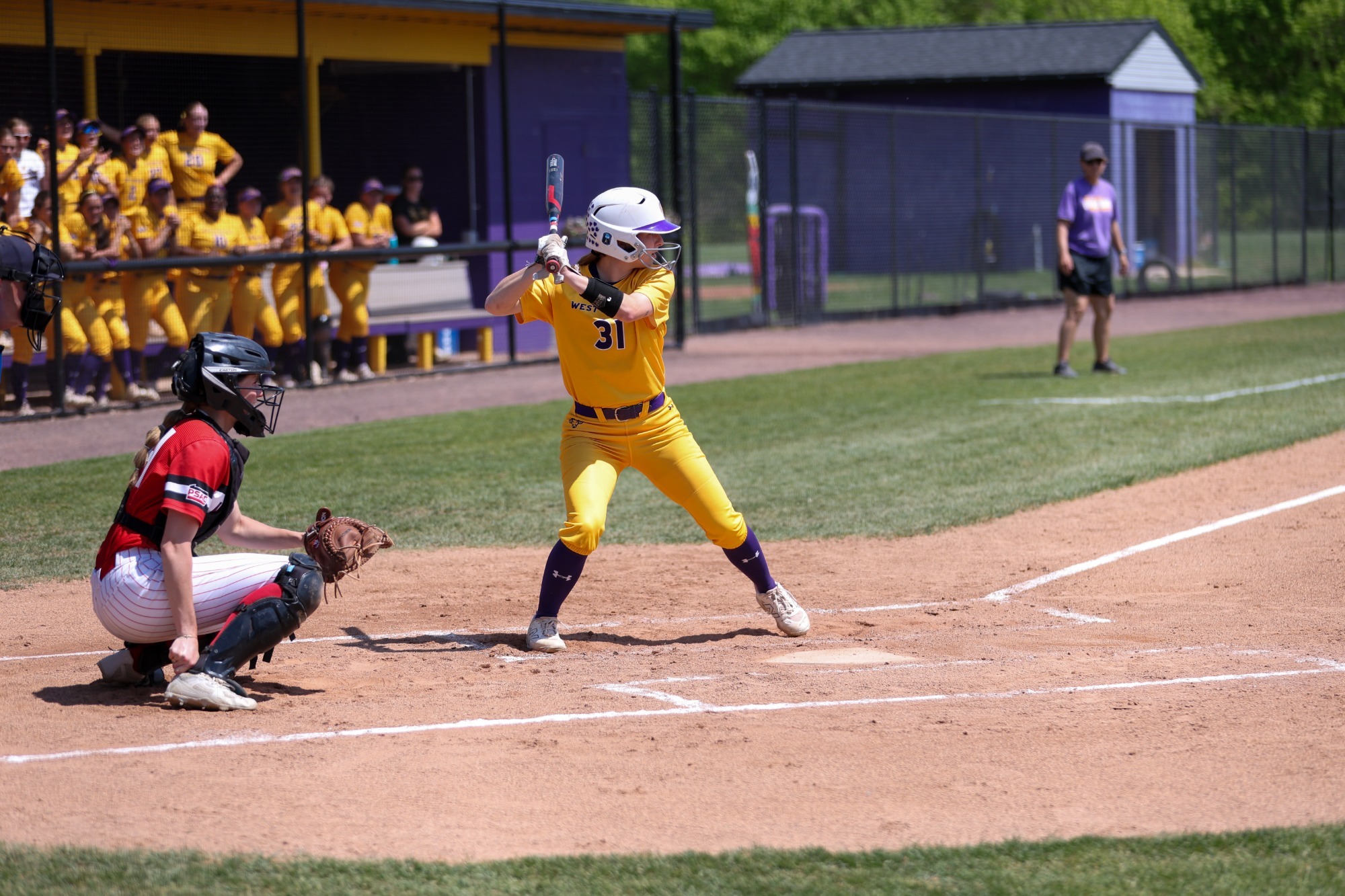 Tess Kearney up to bat vs ESU wearing all gold home uniforms in doubleheader on Friday afternoon