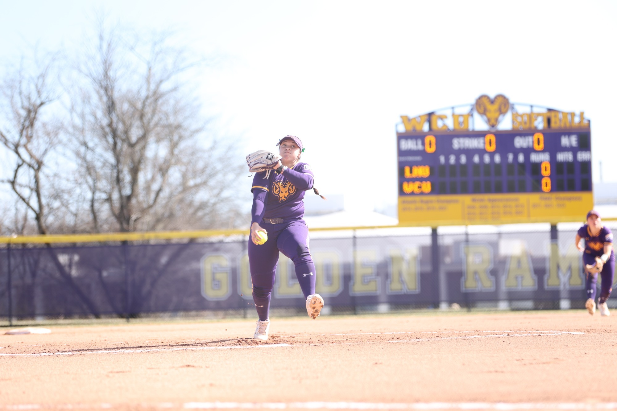 Alyssa Tooley pitching in new home all purple uniforms vs Lock Haven