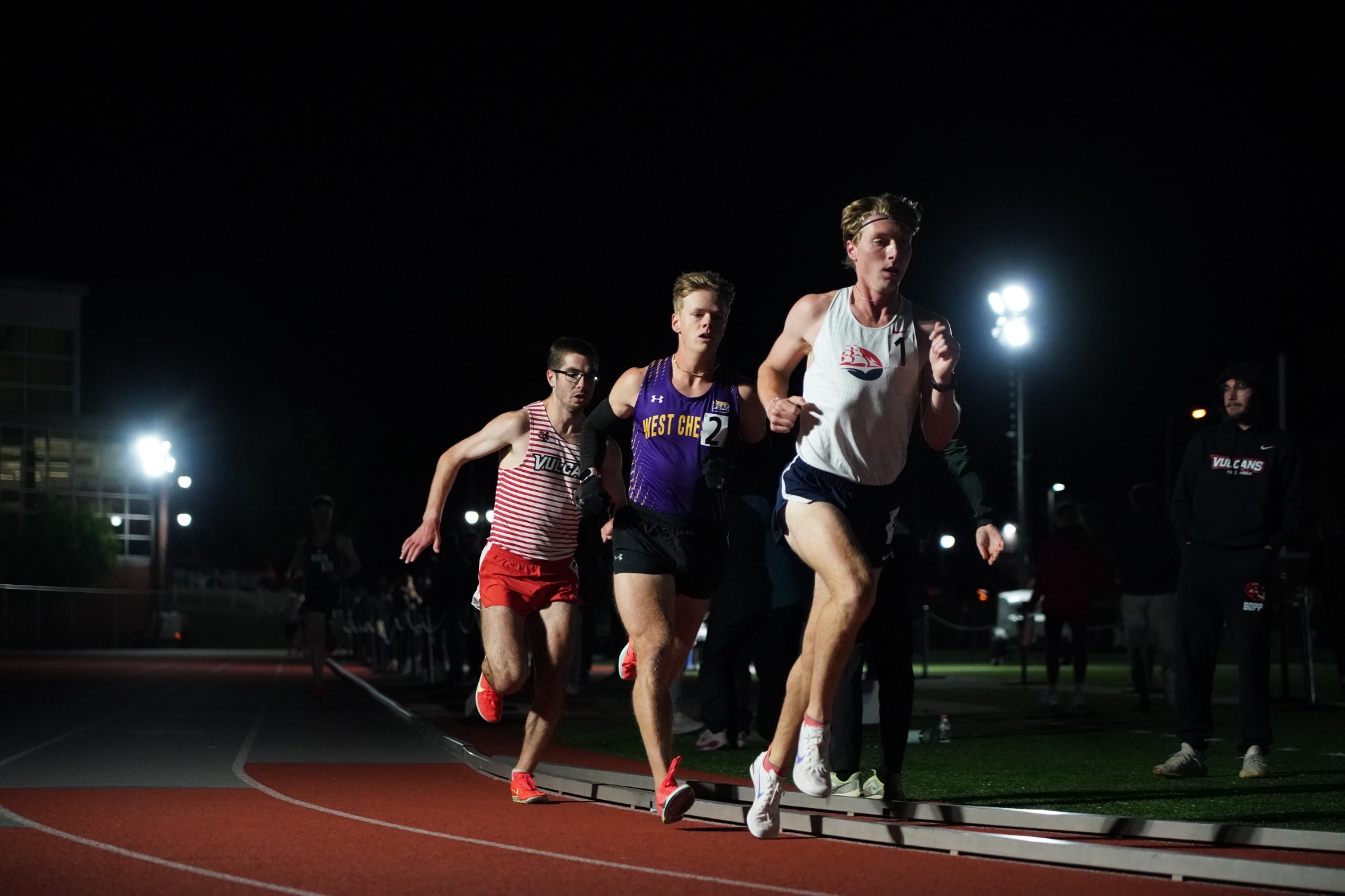 Josh Miller racing in 10k under the lights at Shippensburg at 2026 PSAC Outdoor Championships on Thursday night