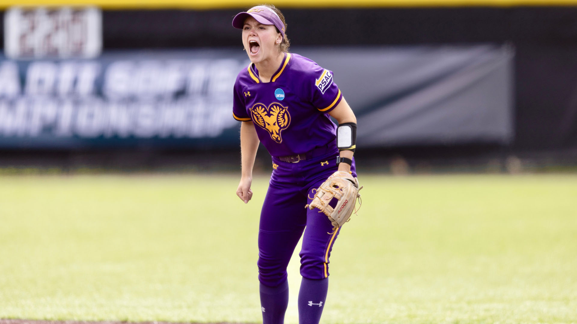 Kayla Fitzpatrick yelling while playing her position at second base in West Chester's purple uniform with the ram head logo on the front and purple pants