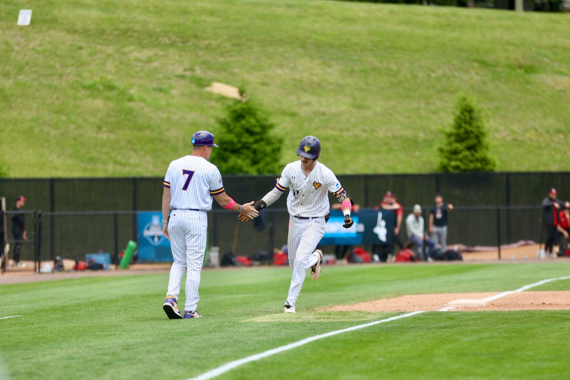 Carter Rust rounds third base and gives head coach Mike LaRosa a high-five after hitting the Golden Rams second home run of the day to give WCU a 6-4 lead in the third inning on Friday