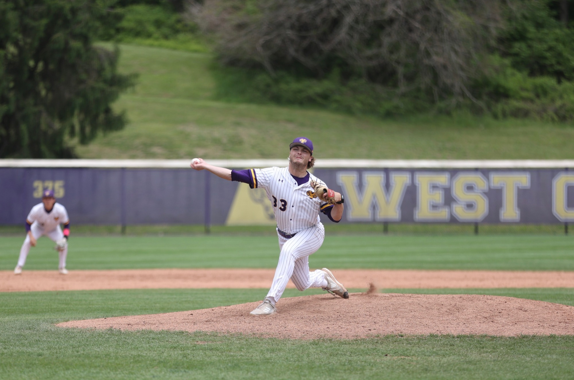 Kyle Lazer wearing home white pinstripes pitches vs ESU in Atlantic Regional Tournament at WCU on Friday Afternoon