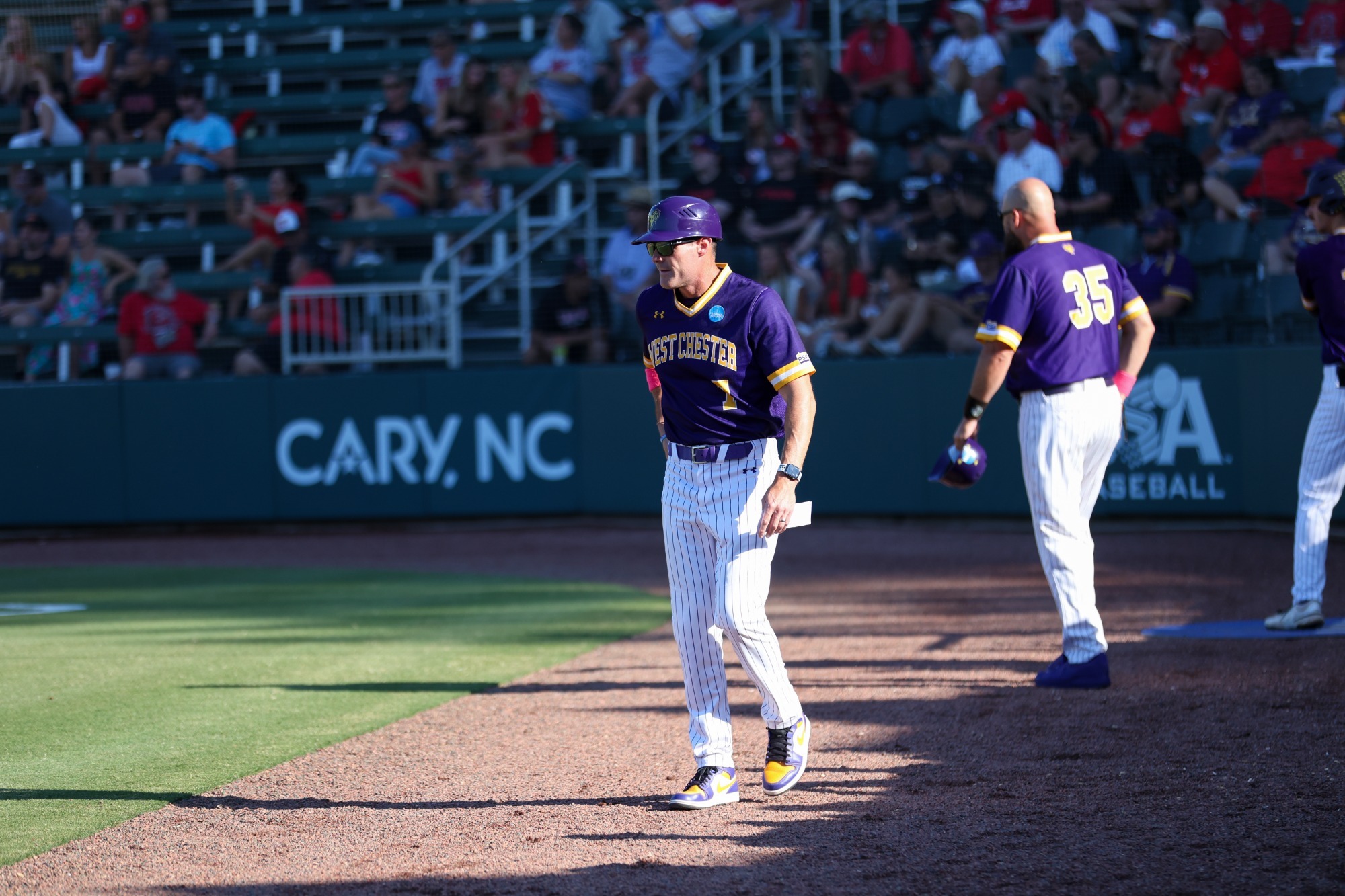 HEAD COACH MIKE LAROSA WALKING TOWARD THIRD BASE COACHES BOX IN GAME ONE OF NATIONAL CHAMPIONSHIP SERIES VS TAMPA IN CARY, NORTH CAROLINA