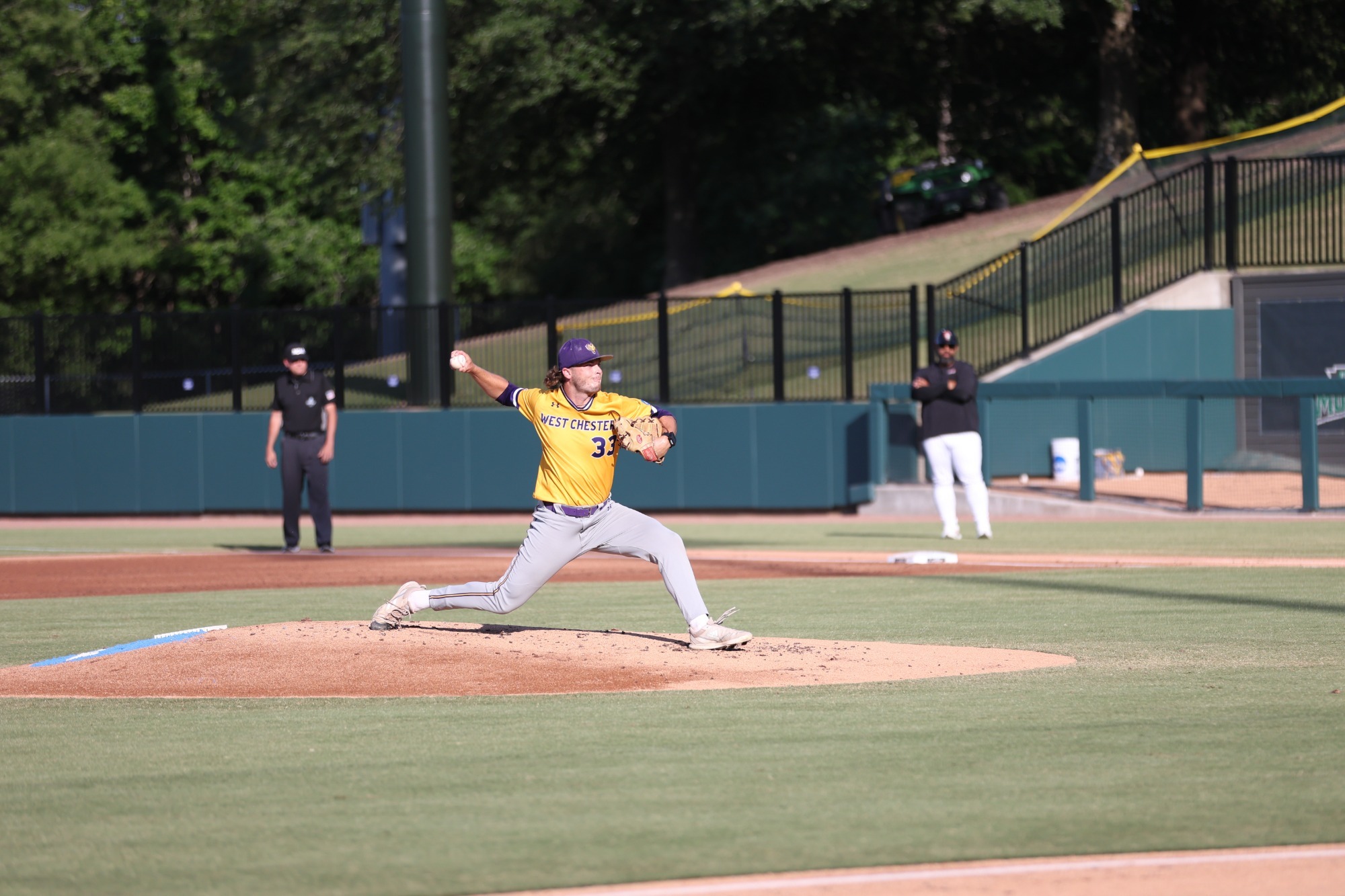 Lazer wearing gold top and gray pants pitching vs Tampa in game two of national championship series on friday june 5