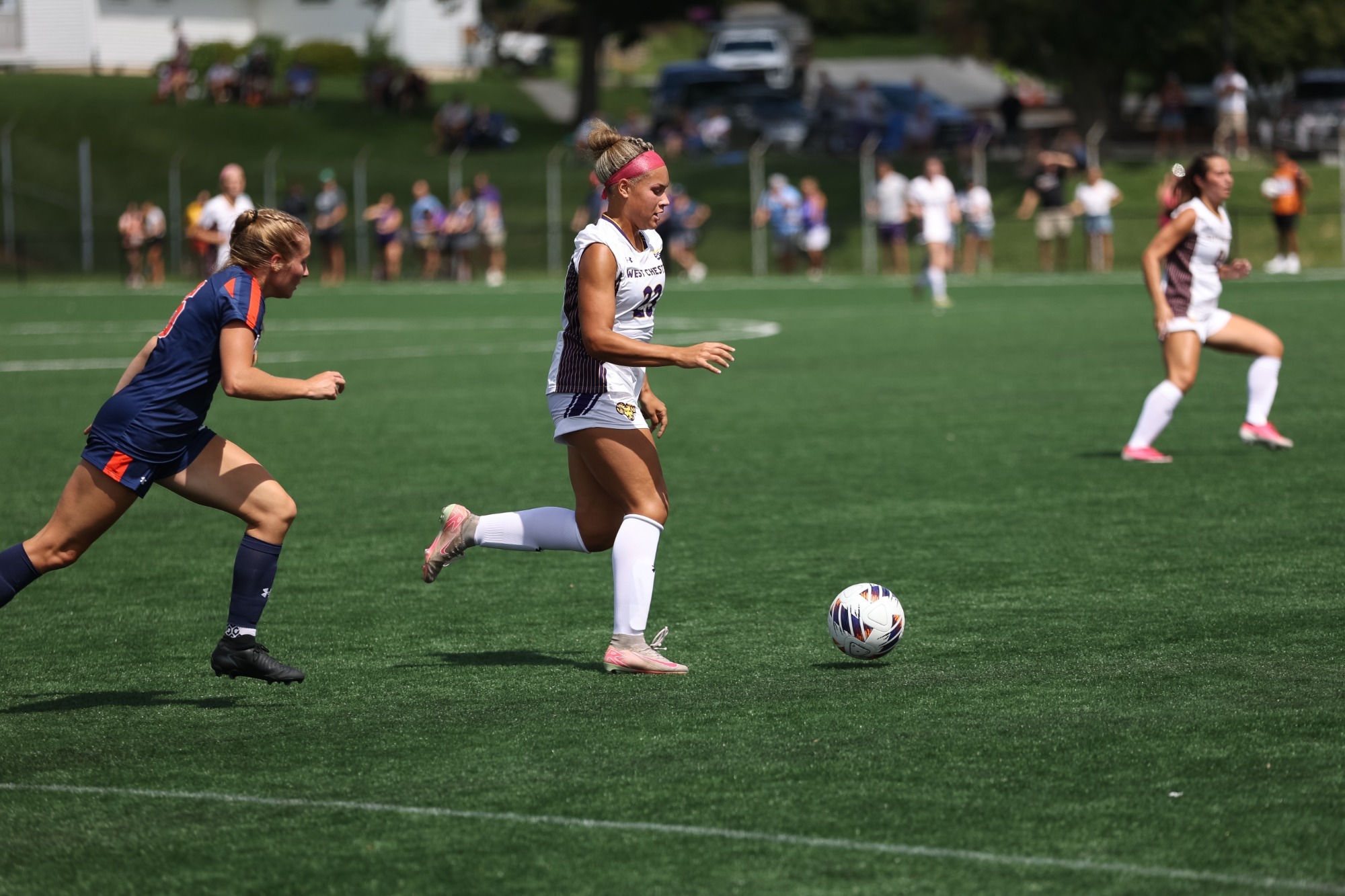 Kianna Barber wearing home white uniform carries the ball past a Lackawanna defender in a 6-0 win over the Falcons