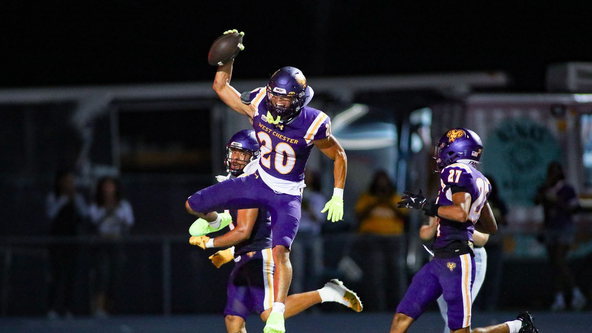 Bryan Anderson celebrates his 66-yard scoop and score at night inside Farrell Stadium in West Chester's purple uniforms with purple helmets and purple pants