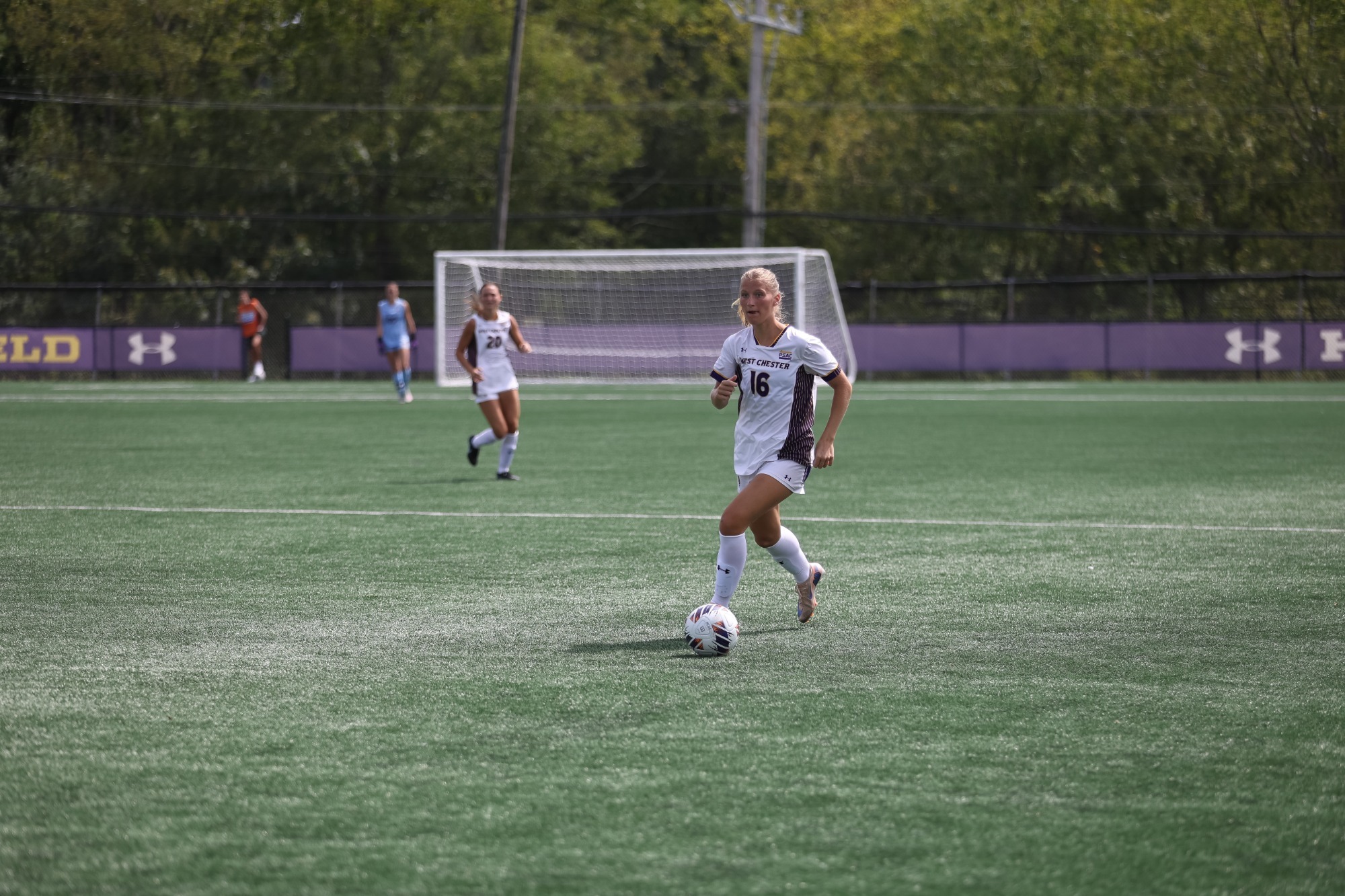 CHLOE BUCHER WEARING HOME WHITE ON WHITE KIT BRINGS THE BALL UP FIELD VS LACKAWANNA IN THE GOLDEN RAMS HOME OPENER ON SEPTEMBER 5