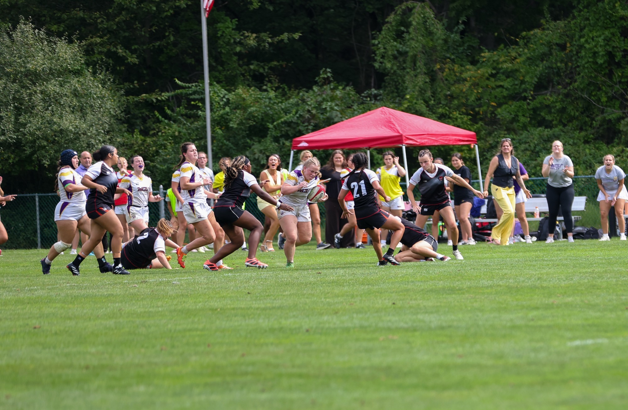 EMMA DAVIES WEARING WCU HOME WHITE ON WHITE KIT BREAKS A TACKLE VS DAVENPORT WEARING BLACK ON BLACK KIT IN NIRA HOME OPENER ON SATURDAY AFTERNOON