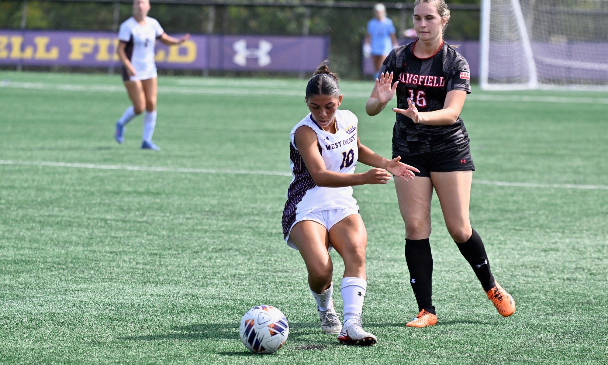 Jenna Eichenbaum wearing home white on white uniform finds space around a Mansfield defender with the ball at her feet during Saturday's game vs Mansfield