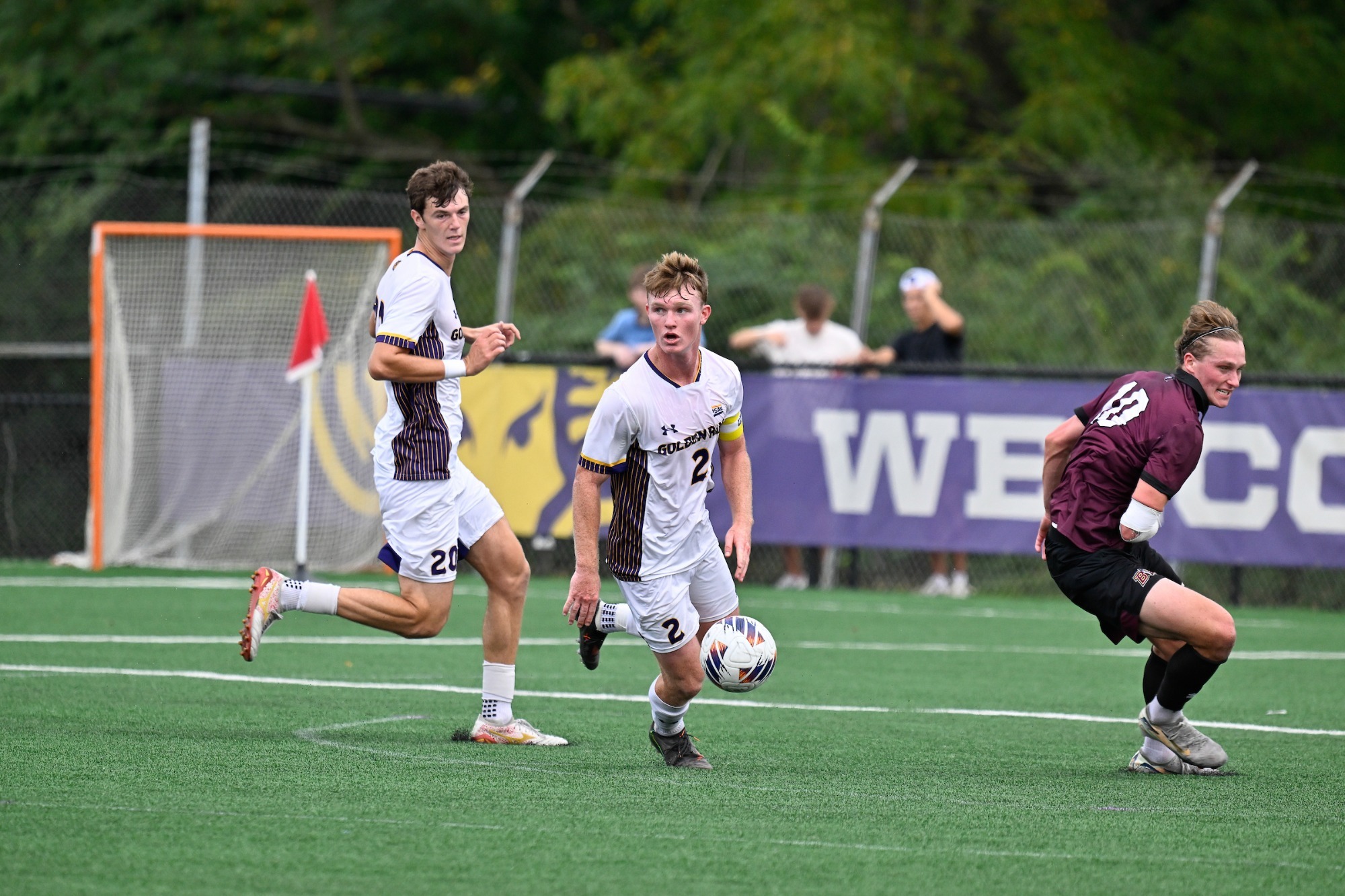 Ian Alicea wearing home white on white kit and captains armband controls a ball to play it upfield vs Bloomsburg on 9-19