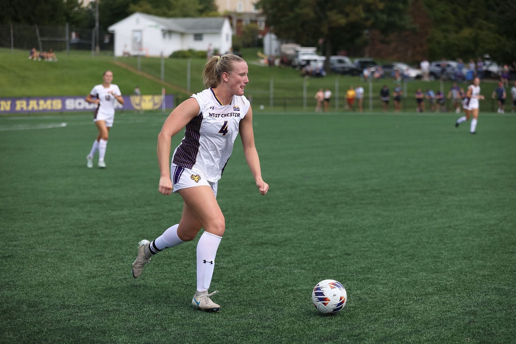 Brielle Zink wearing home on white uniform brings the ball up field vs lackawanna on September 5