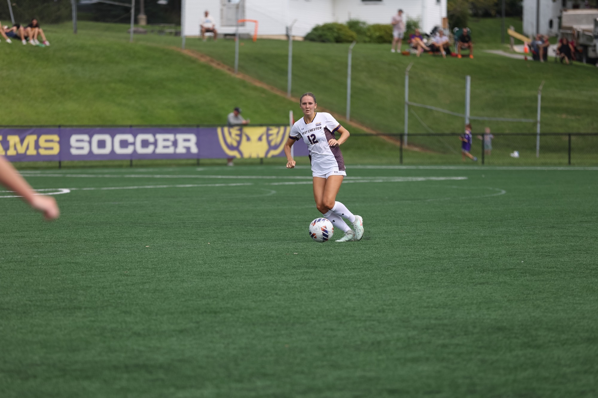 Katie Dougherty wearing home white on white uniform controls the ball vs Lackawanna