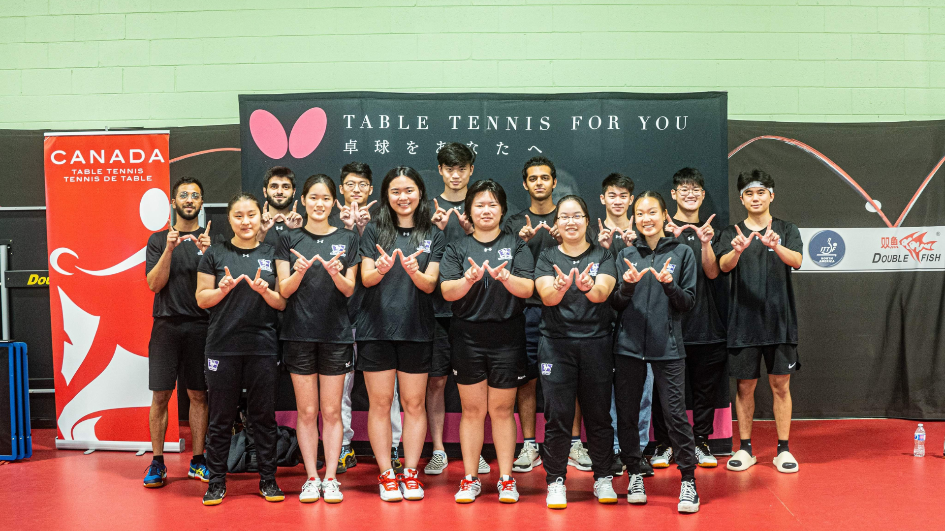 2023-24 Mustangs Table Tennis Team making W signs with their fingers