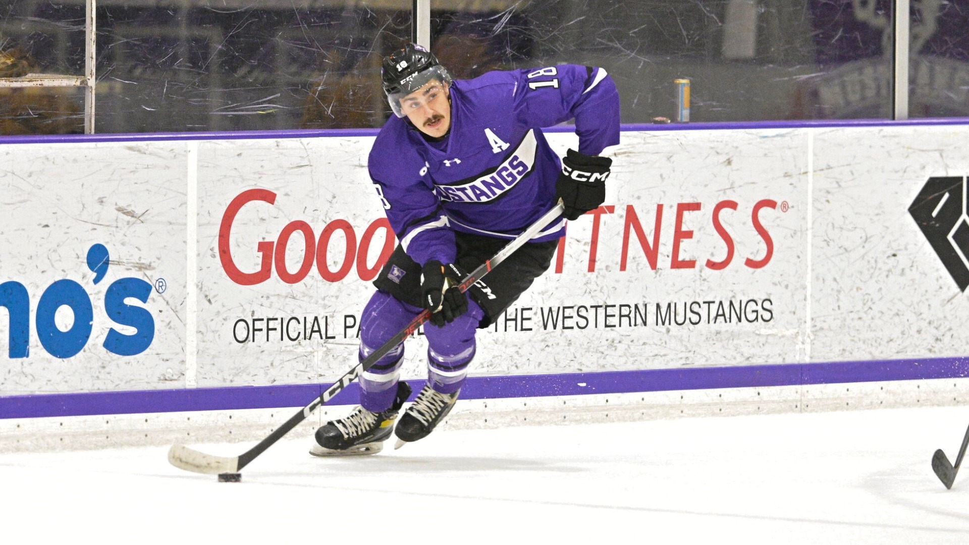 Christian Aiello skates with the puck against Waterloo