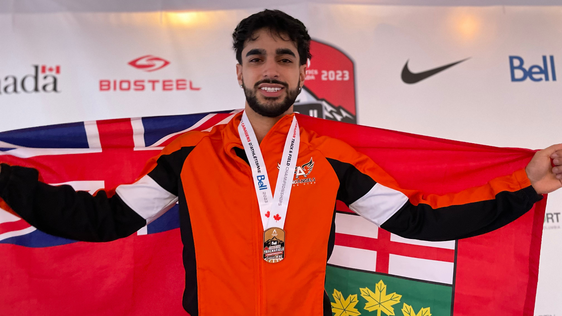 Arman S Track and Field Team holding flag and wearing medal