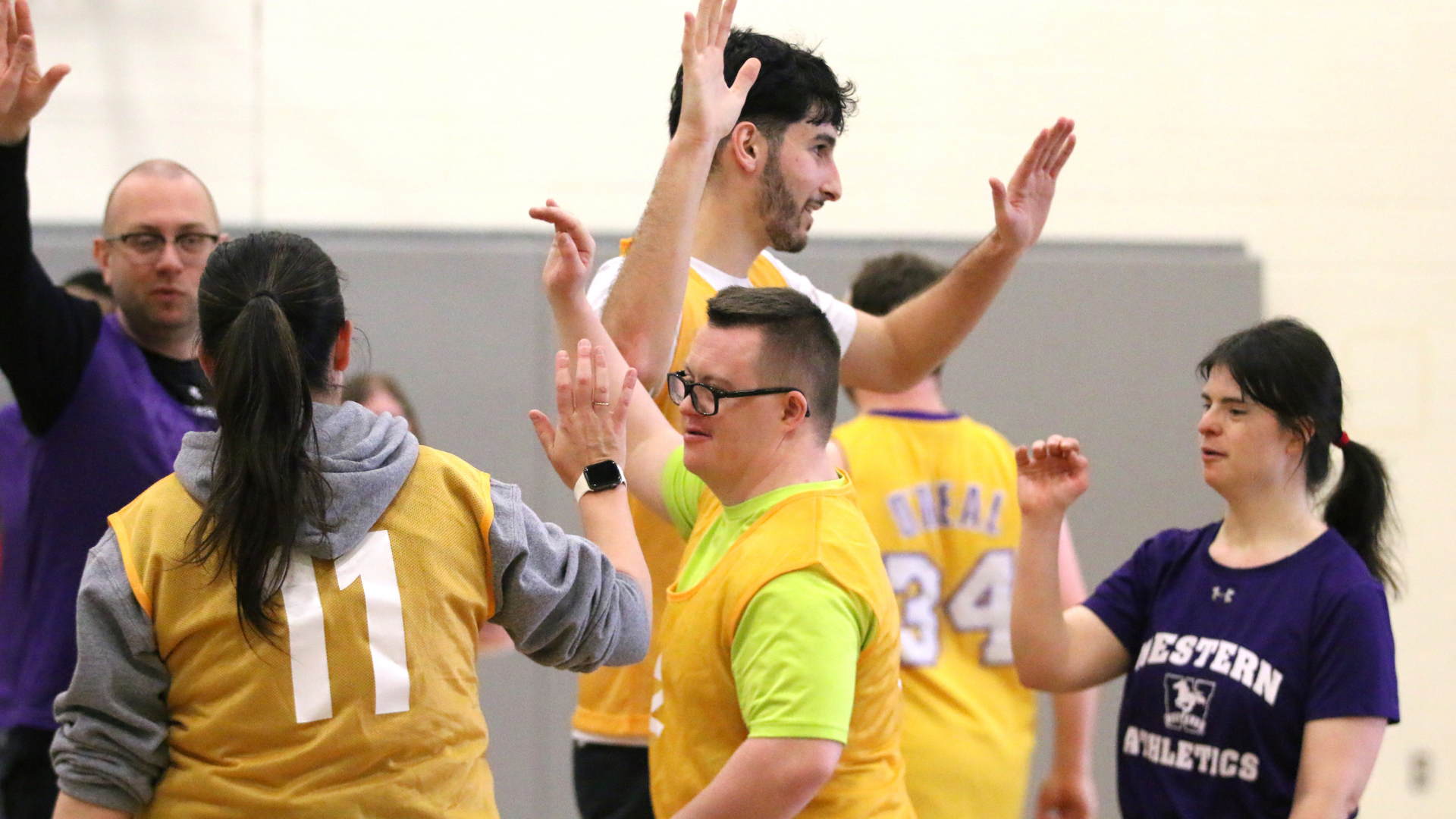 Unified participants give high fives on the court