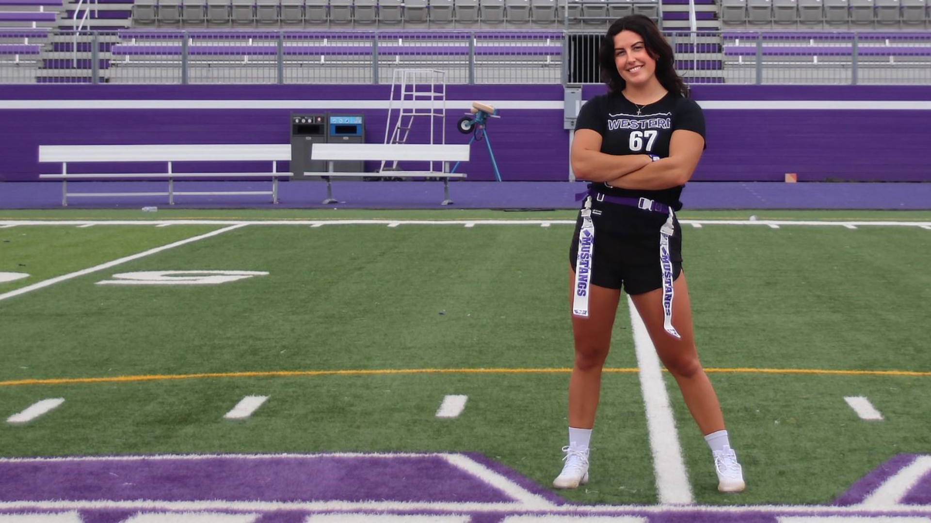 Female student athlete from Western University, Jordyn H, stands on Mustangs Field