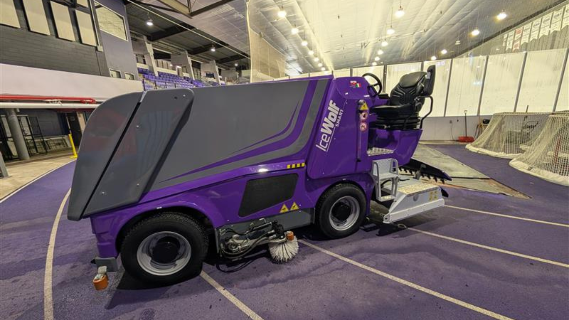 Photo of purple Electric Ice Re-surfacer getting ready to go on an ice rink