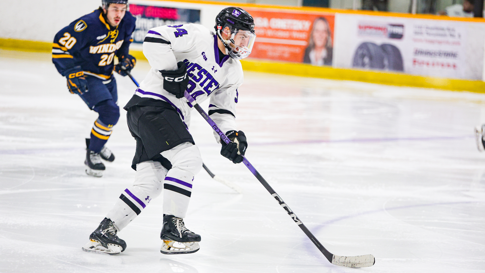 Brett Willits plays the puck against Windsor