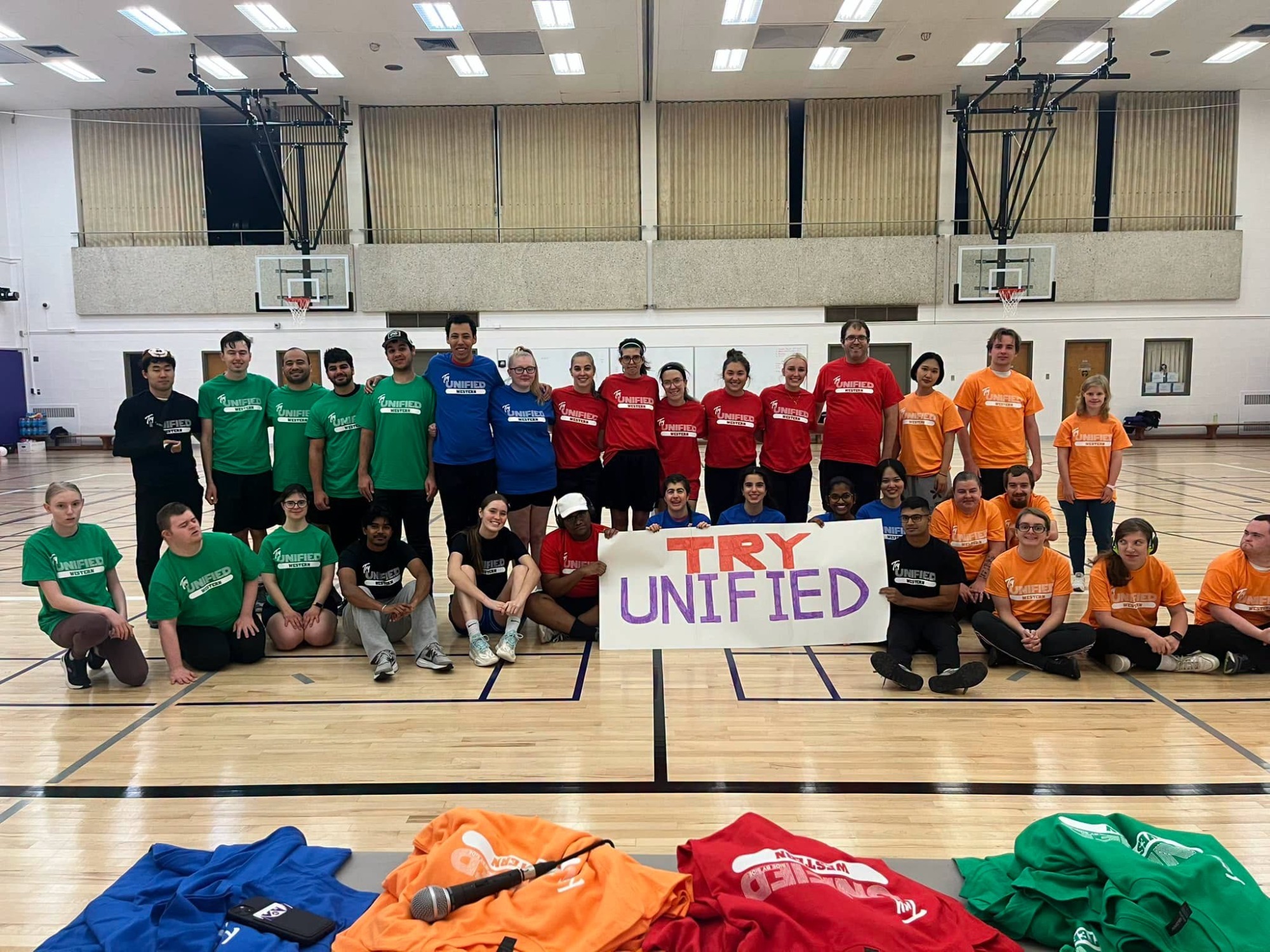 Try Unified Day 2026 all teams together posing in gym