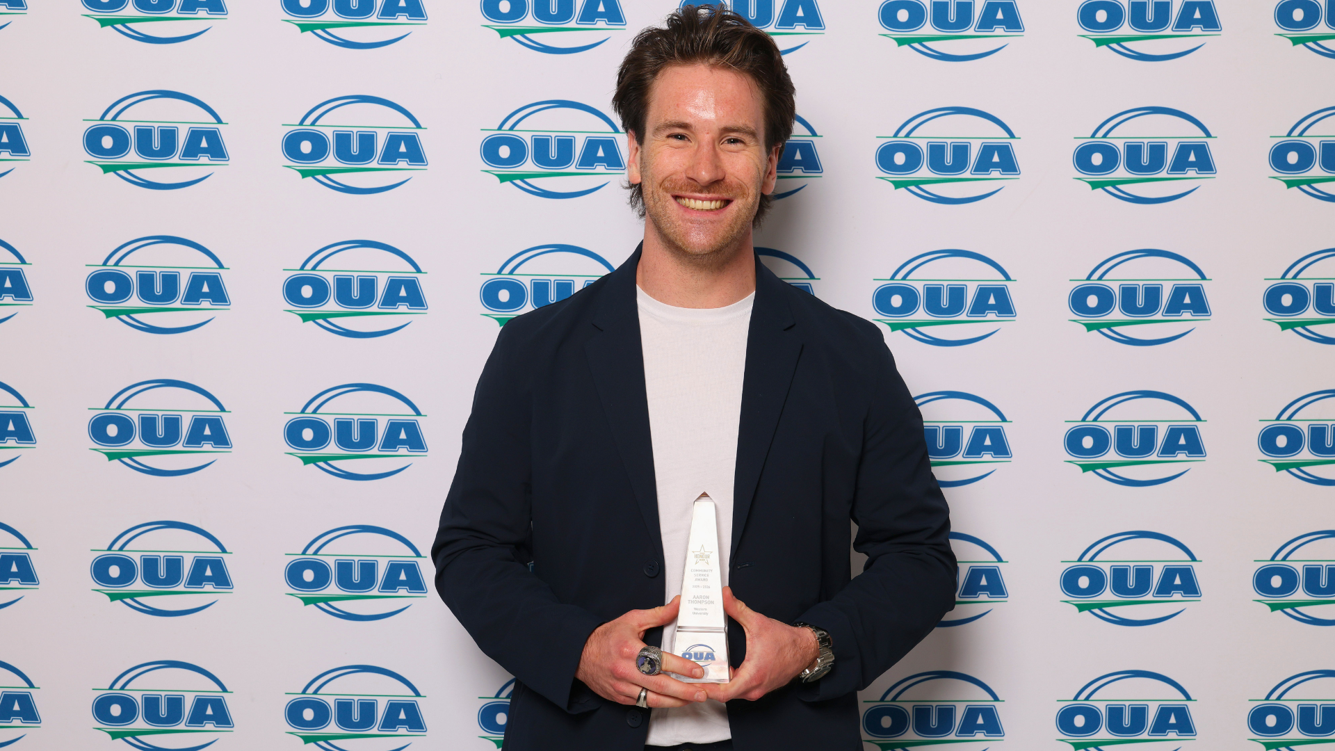 Aaron Thompson with his 2026 OUA Community Service Award Trophy
