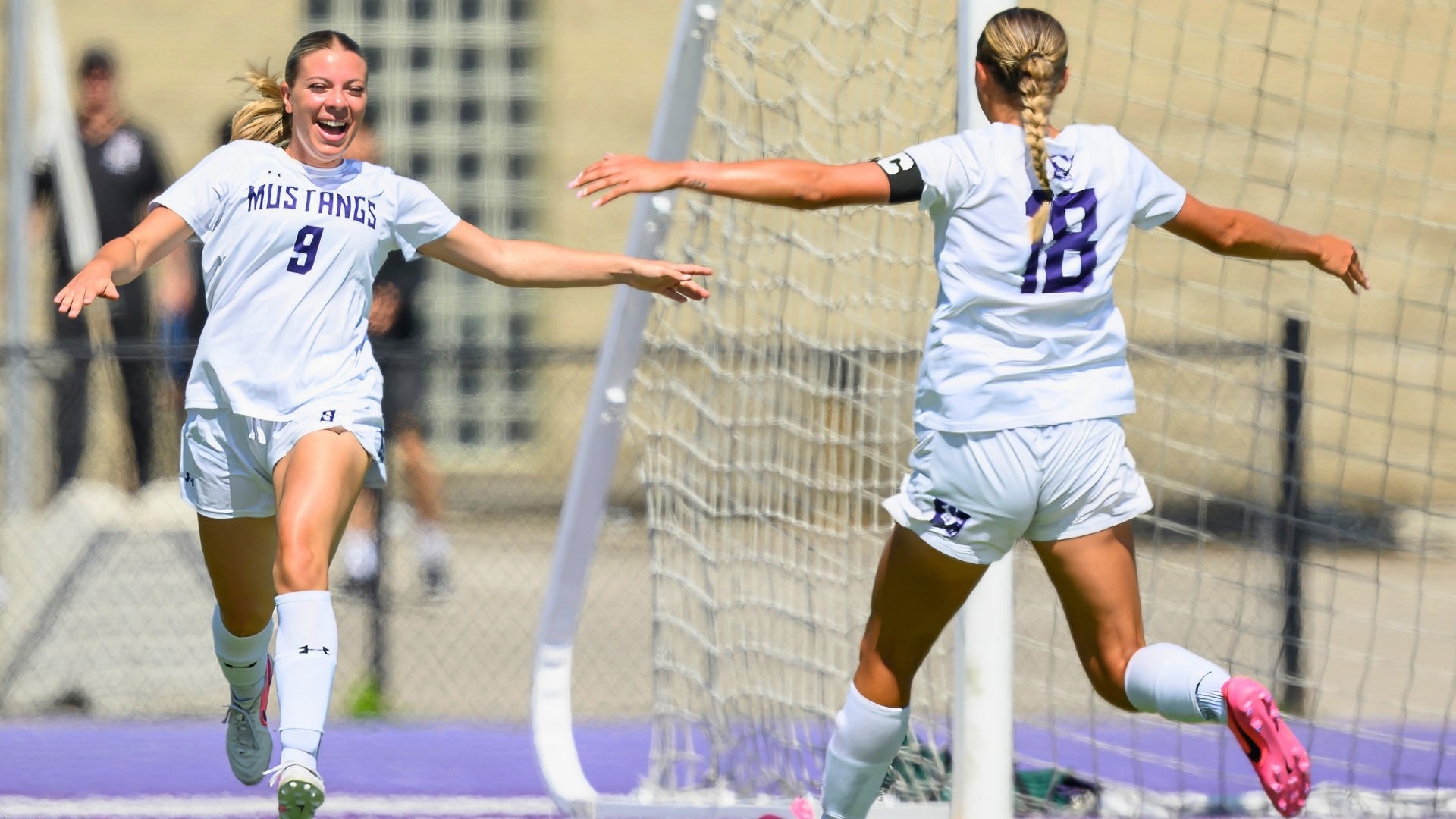 Miranda Preece celebrates with Emily Foster against Waterloo