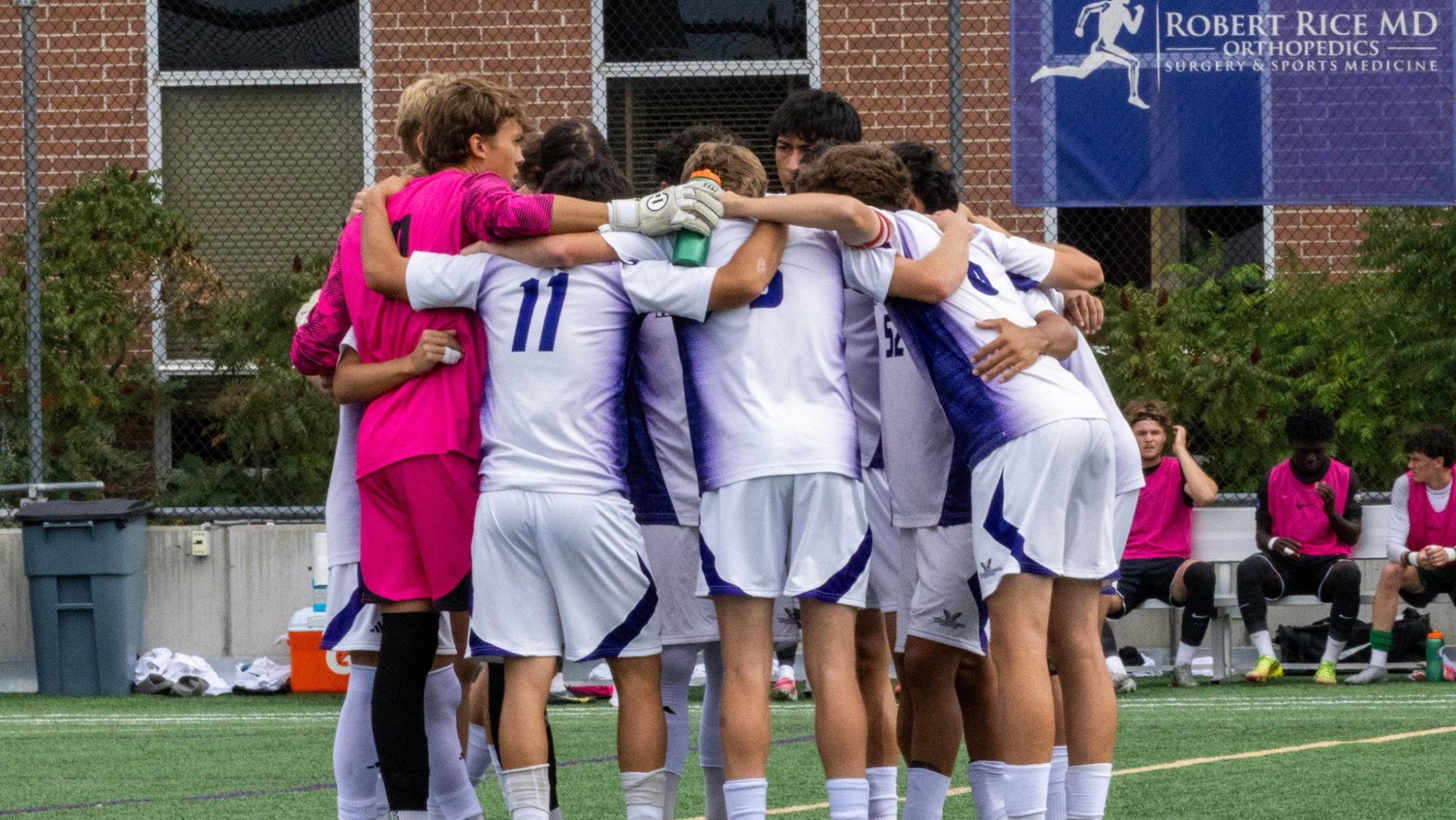 Men's soccer in a huddle