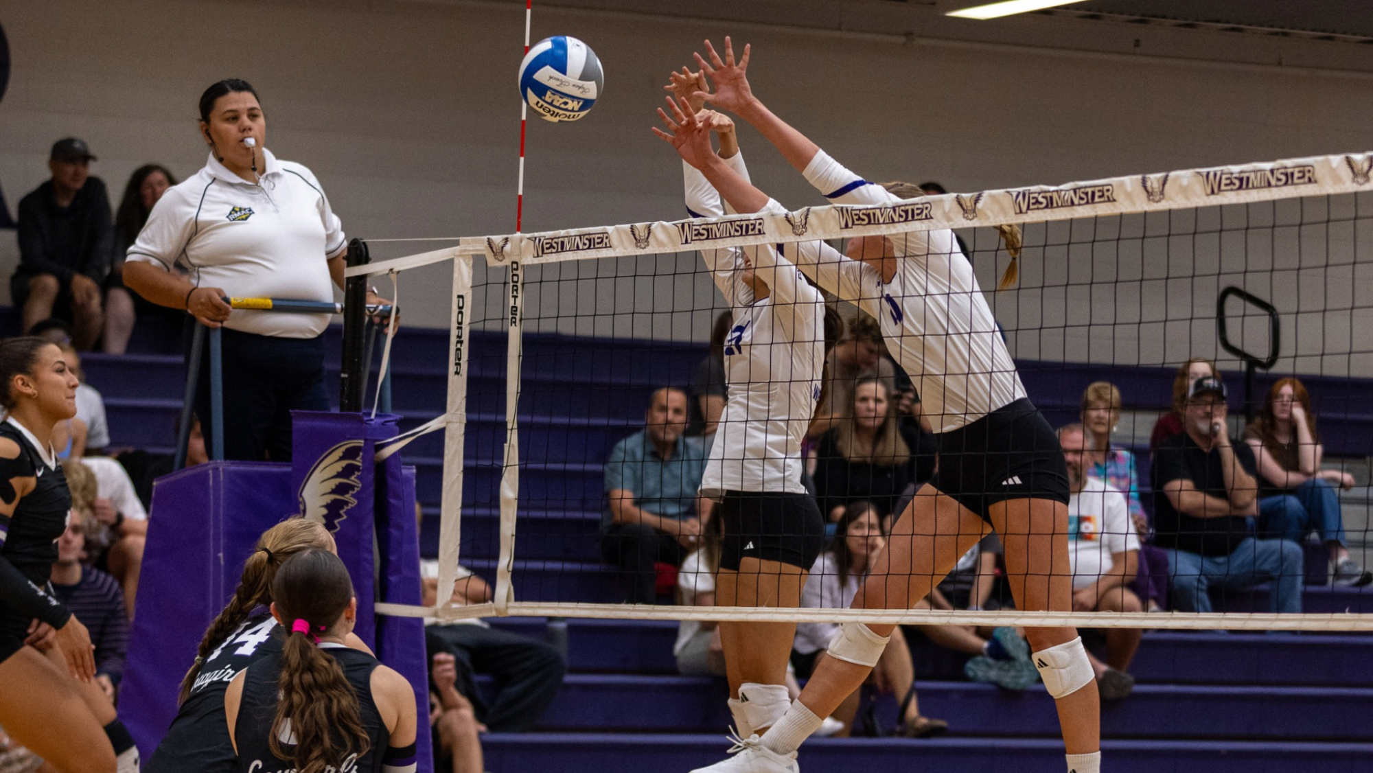 Two Griffin Volleyball players make a block for a point