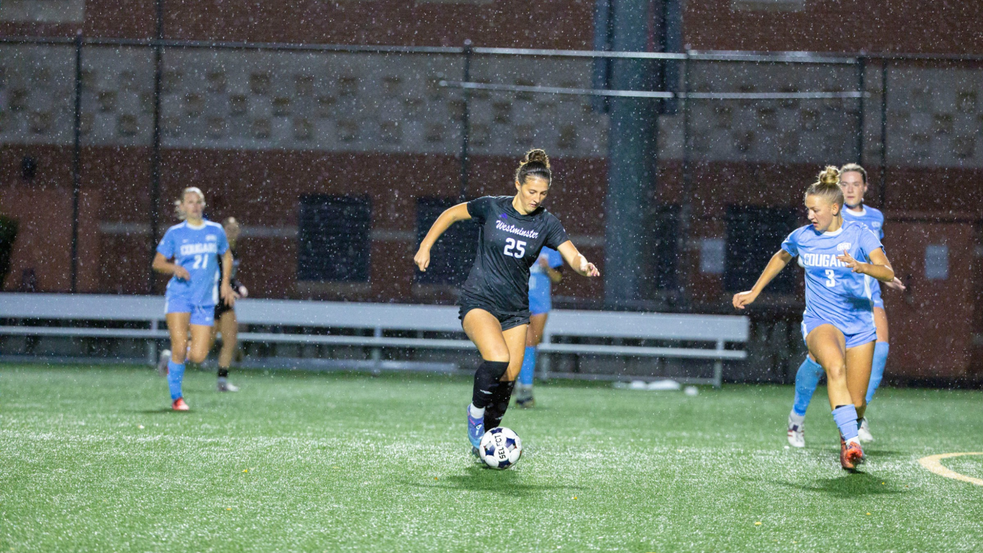 Laine Romney dribbling through CCU defenders