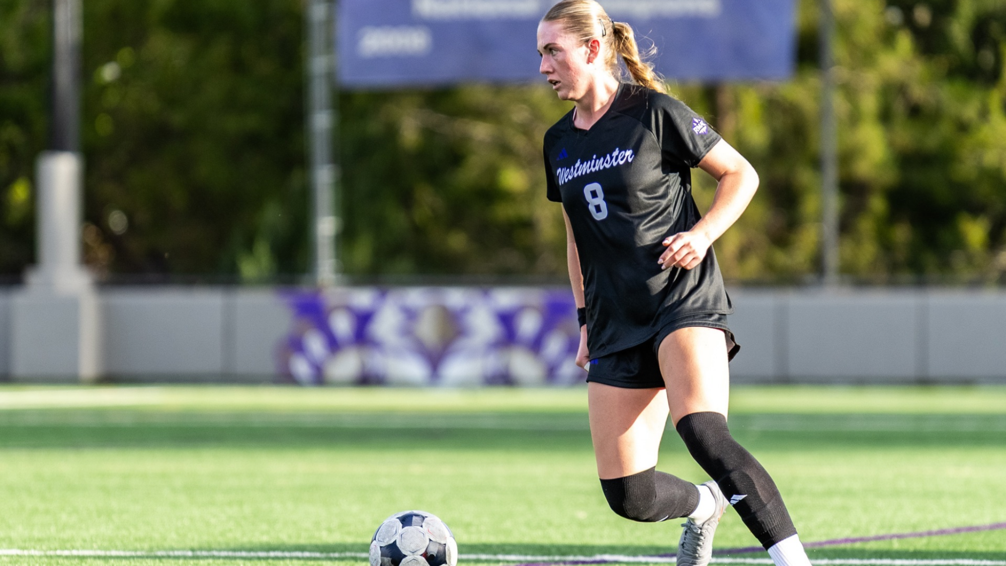 Ella looking to pass , dribbling up field
