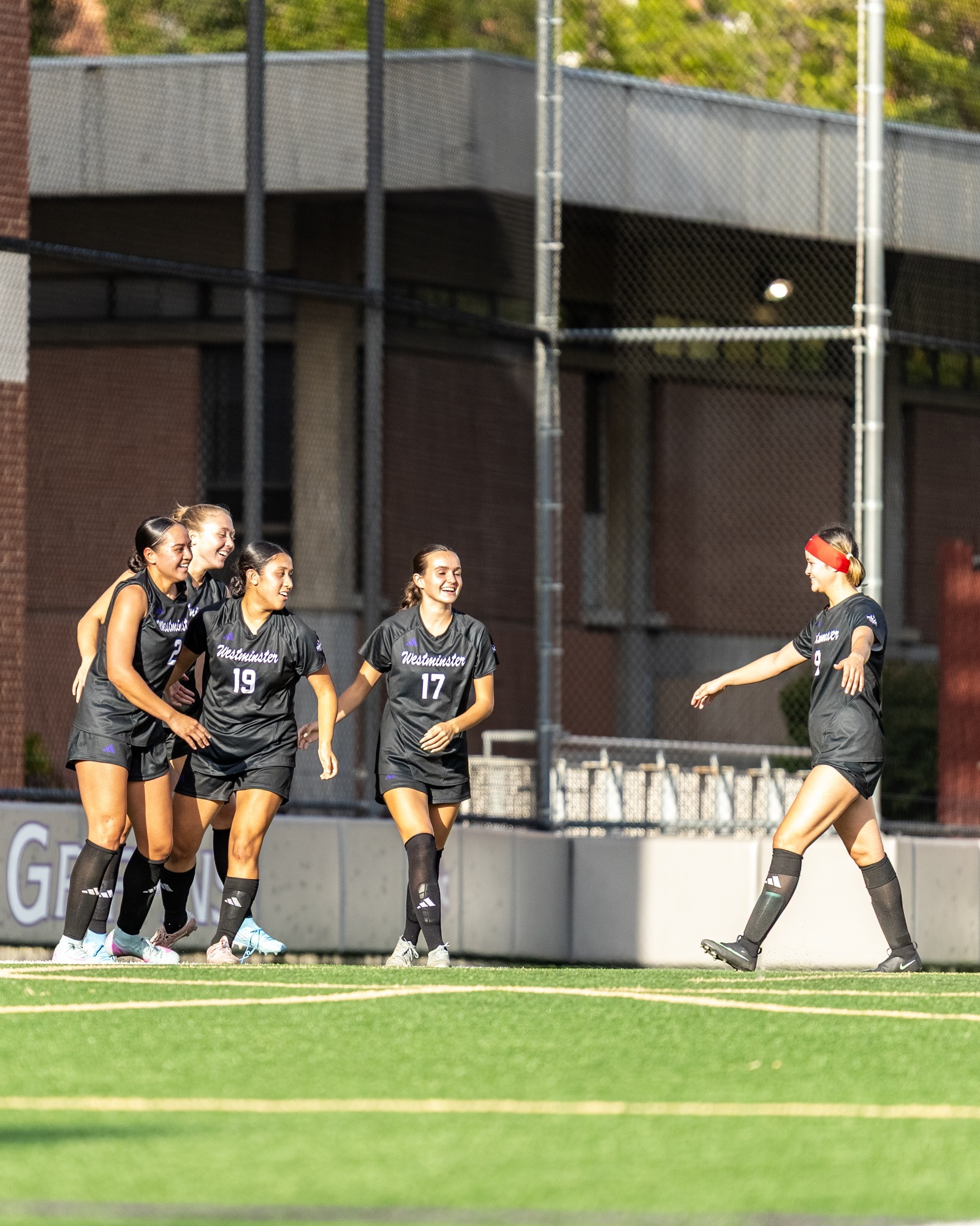 Women's soccer celebrating