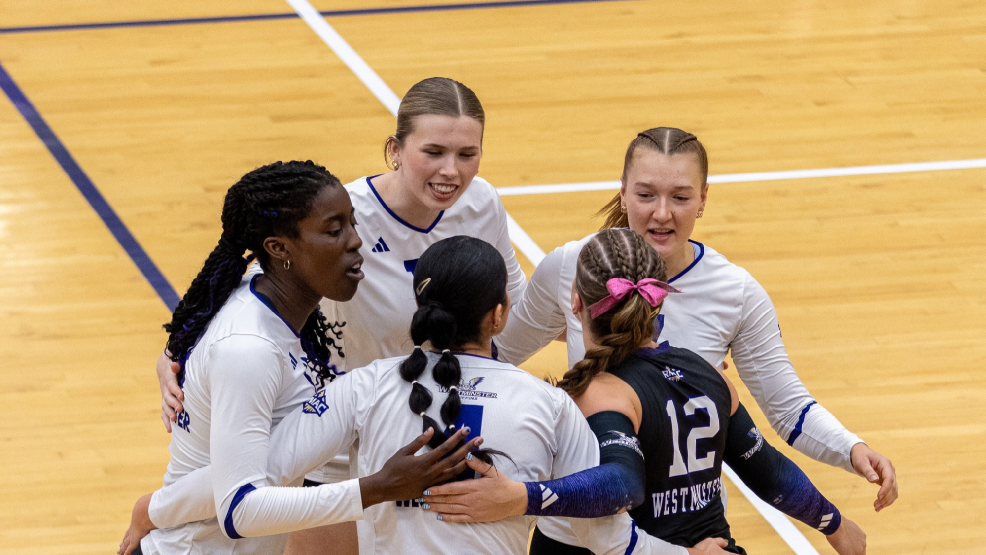 Volleyball team huddling after point