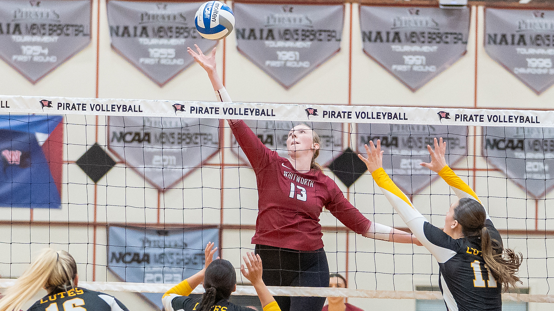 Lauren Kremer reaches high for an attack in the NWC Final vs. PLU