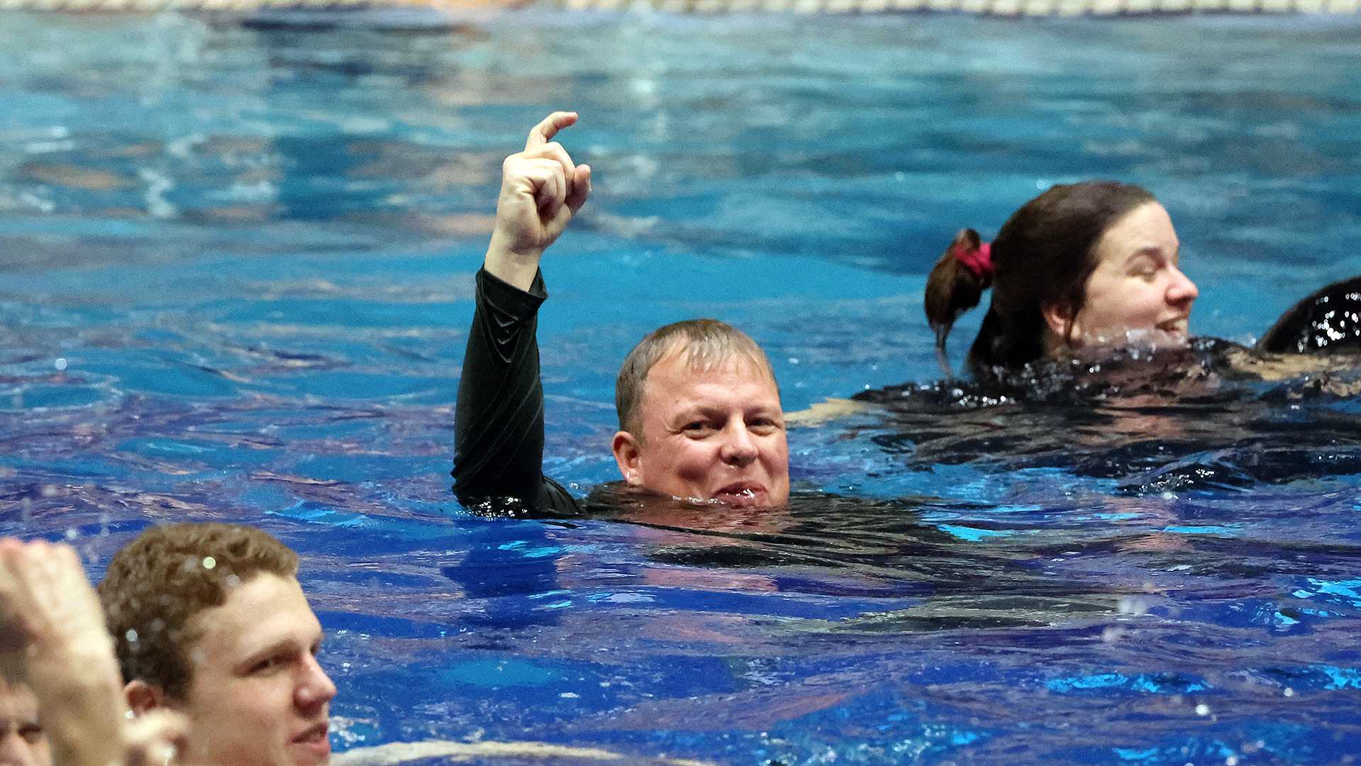 Steve Schadt celebrates with his swimmers after another NWC men's swimming title.