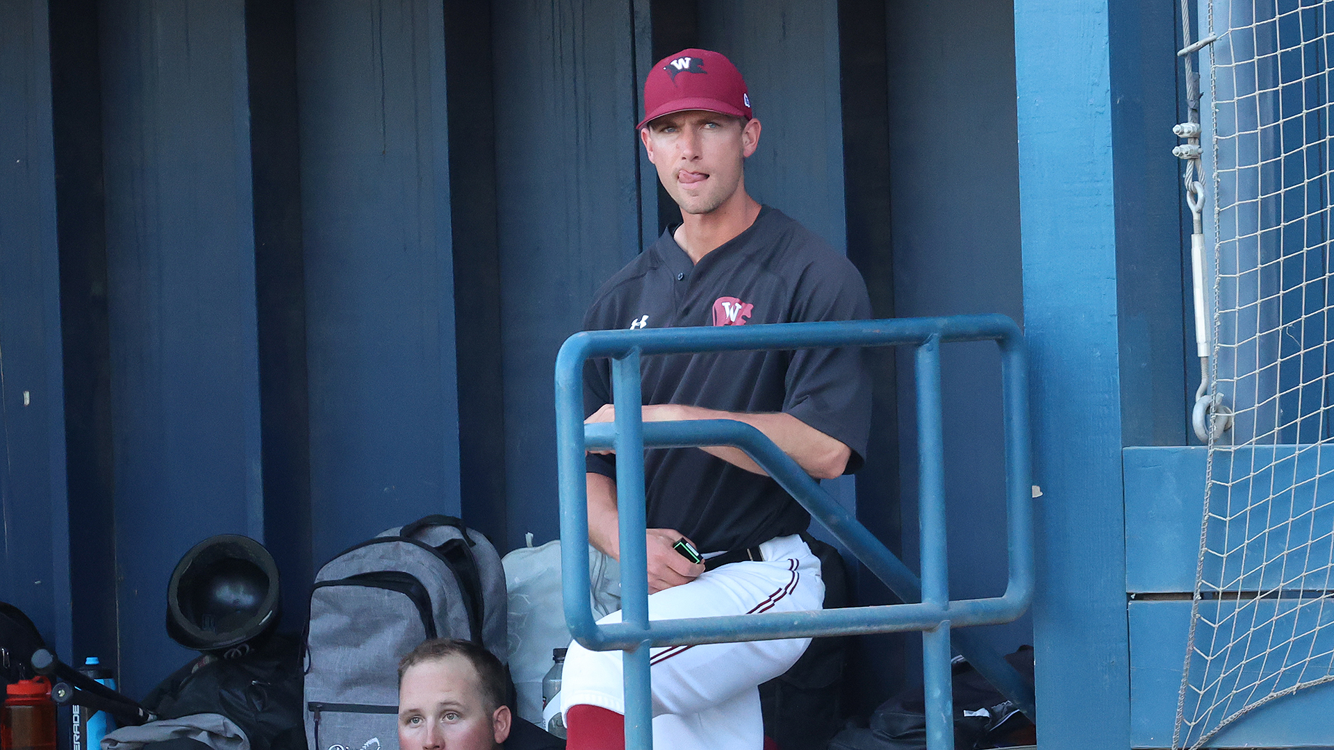 CJ Perry coaches from the dugout vs. Whitman
