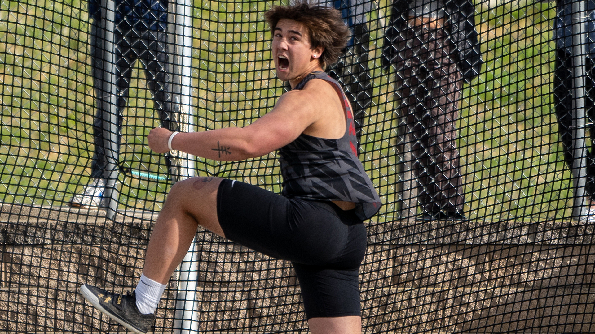 Eddie Vu reacts to his winning discus throw at the last chance meet
