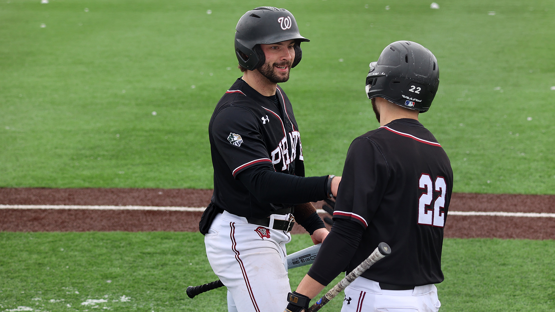 Austin Paul greets Spencer Shipman after the Pirates' first run of 2025
