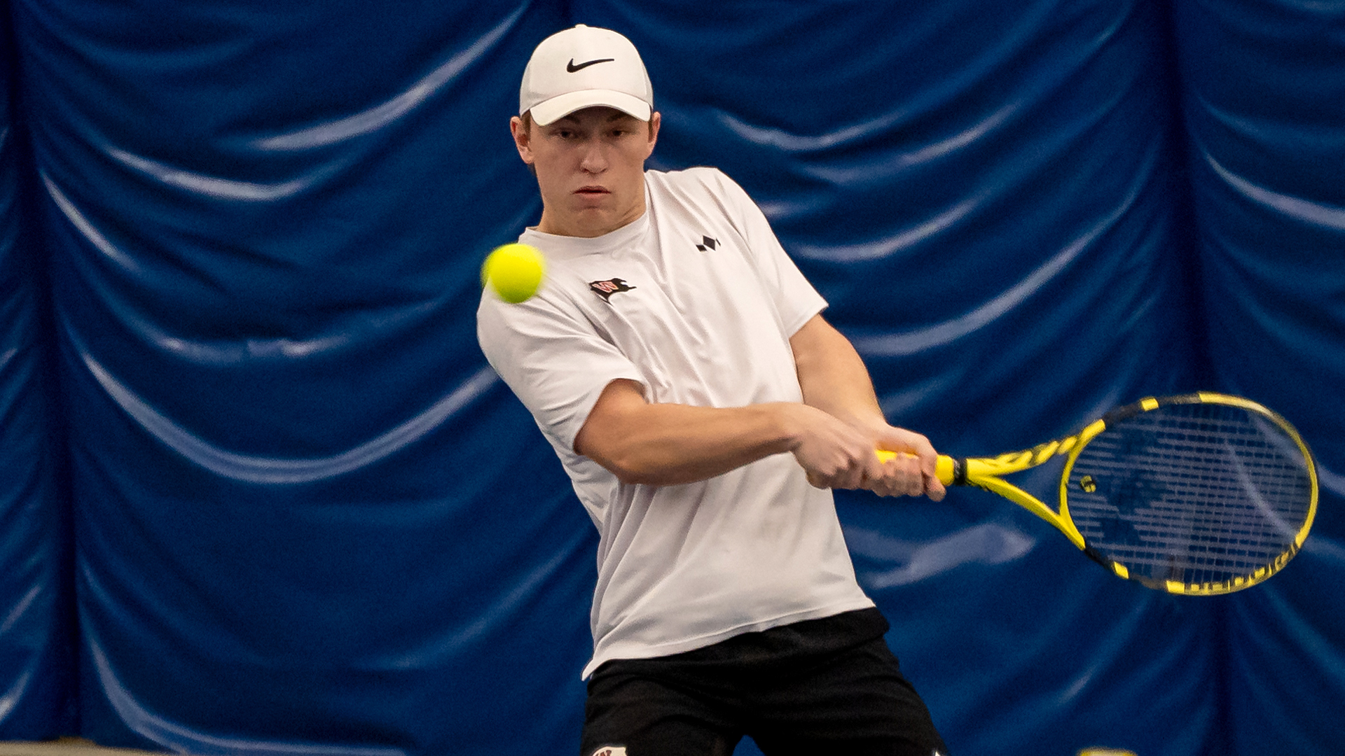 Matt Hossack returns a serve vs. Whitman
