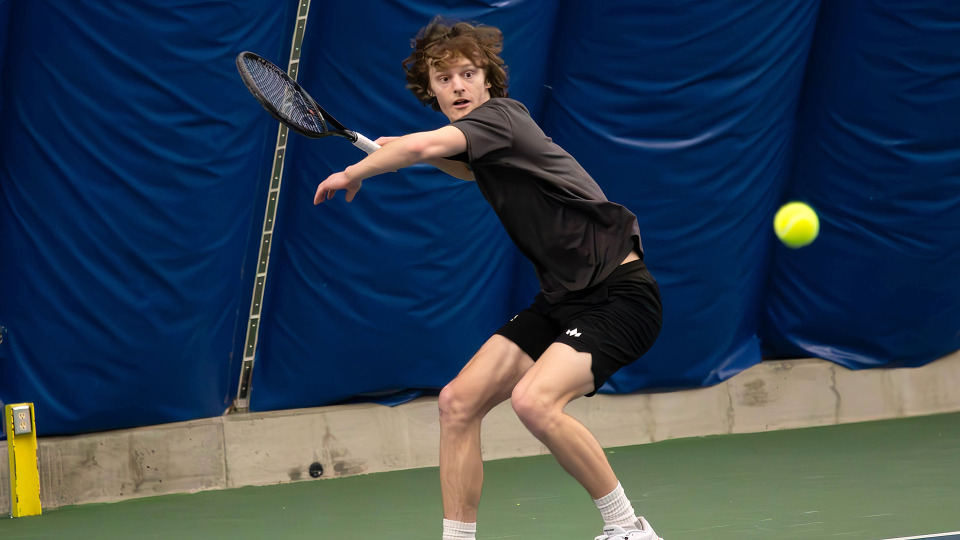 Ryan Ashley returns a serve vs. LCSC