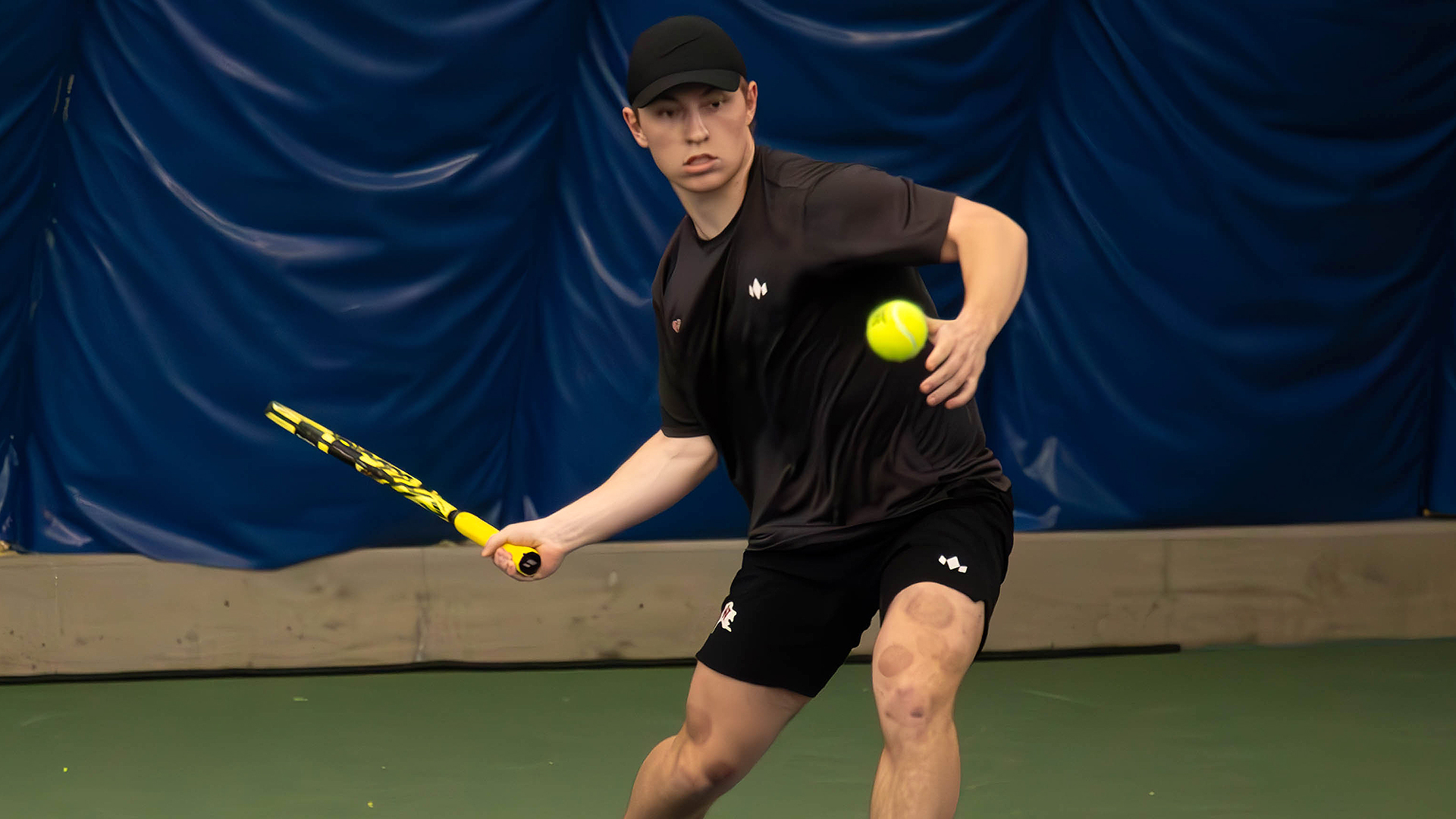 Matt Hossack swings a forehand shot vs. LCSC